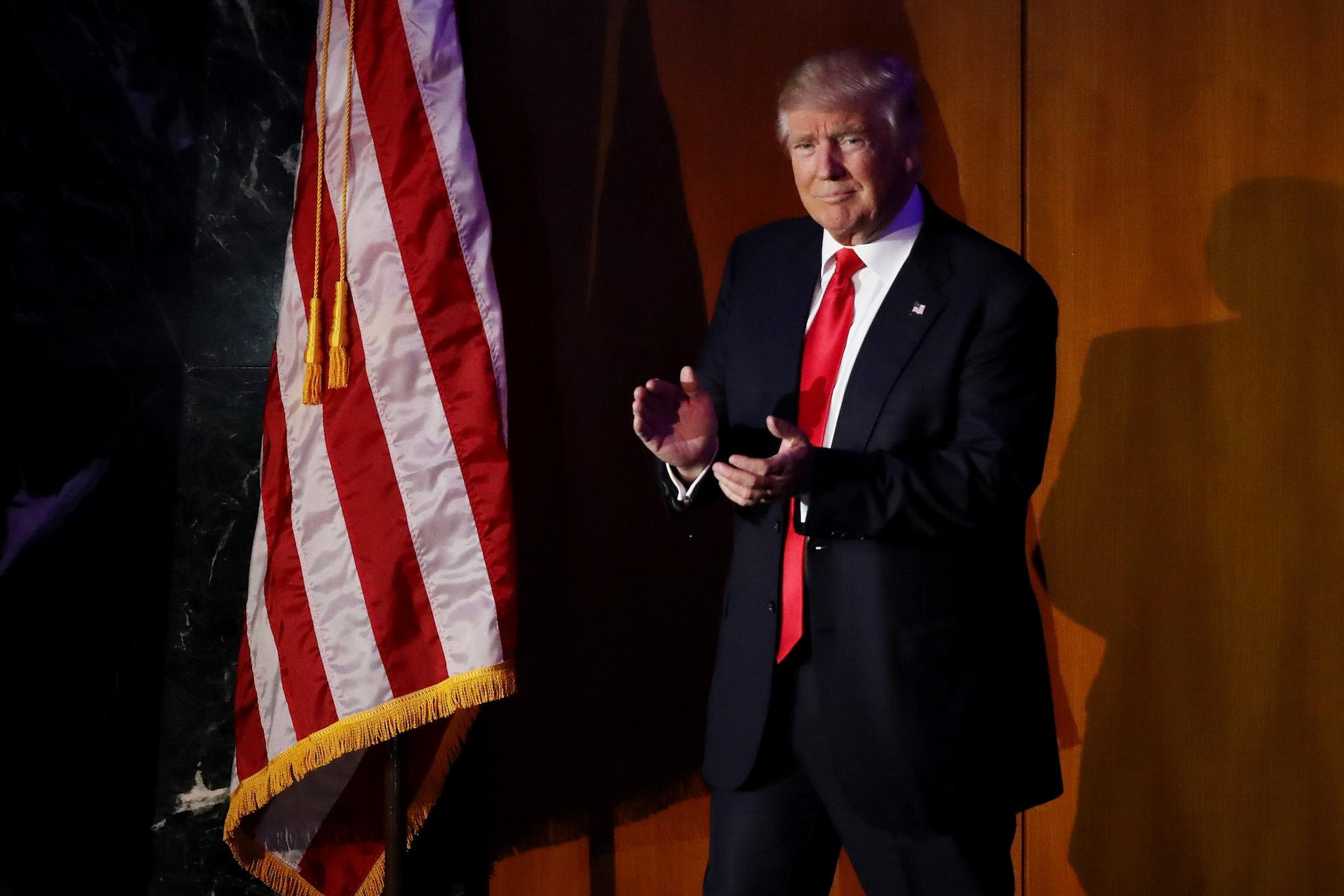 Republican president-elect Donald Trump acknowledges the crowd during his election night event at the New York Hilton Midtown in the early morning hours of November 9, 2016 in New York City