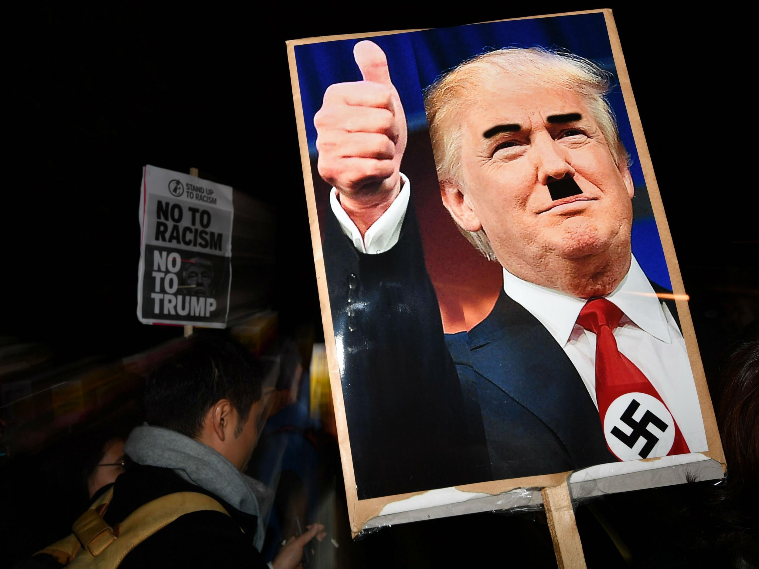 Several signs drew parallels between Adolf Hitler and Donald Trump