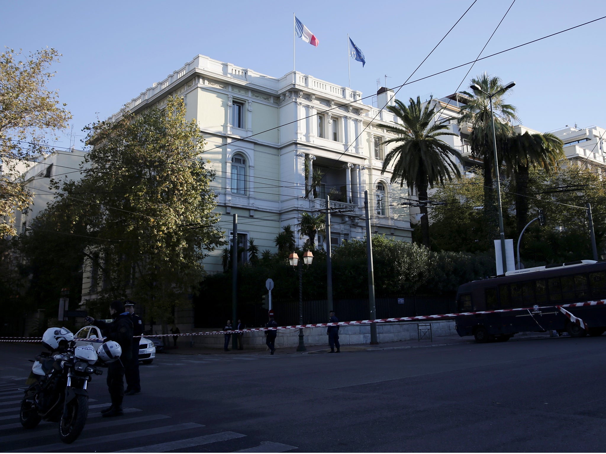 Police stand outside the French embassy in Athens, where unidentified attackers threw an explosive device causing a small blast