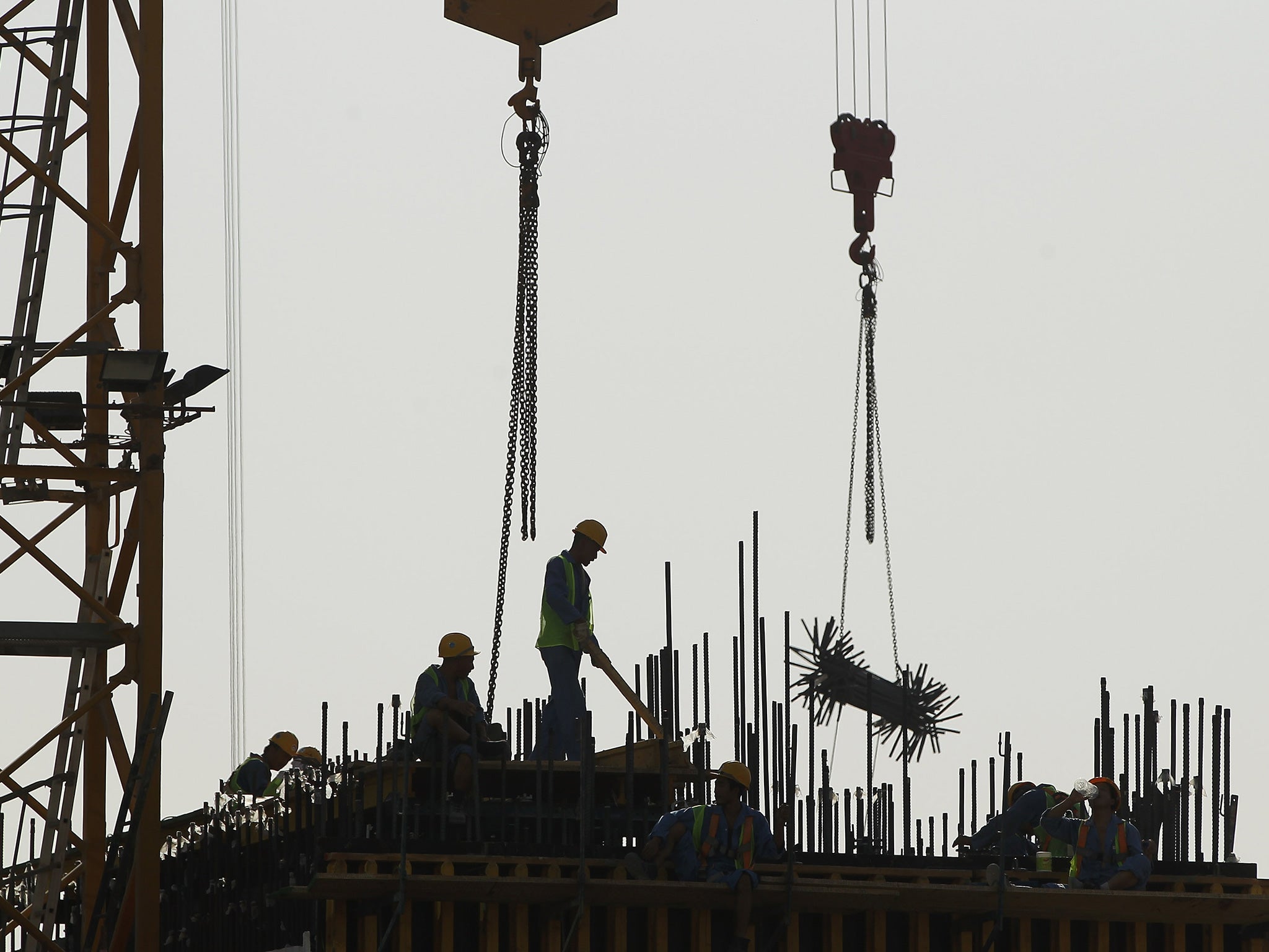 Builders at work on the construction of a new office site in Qatar