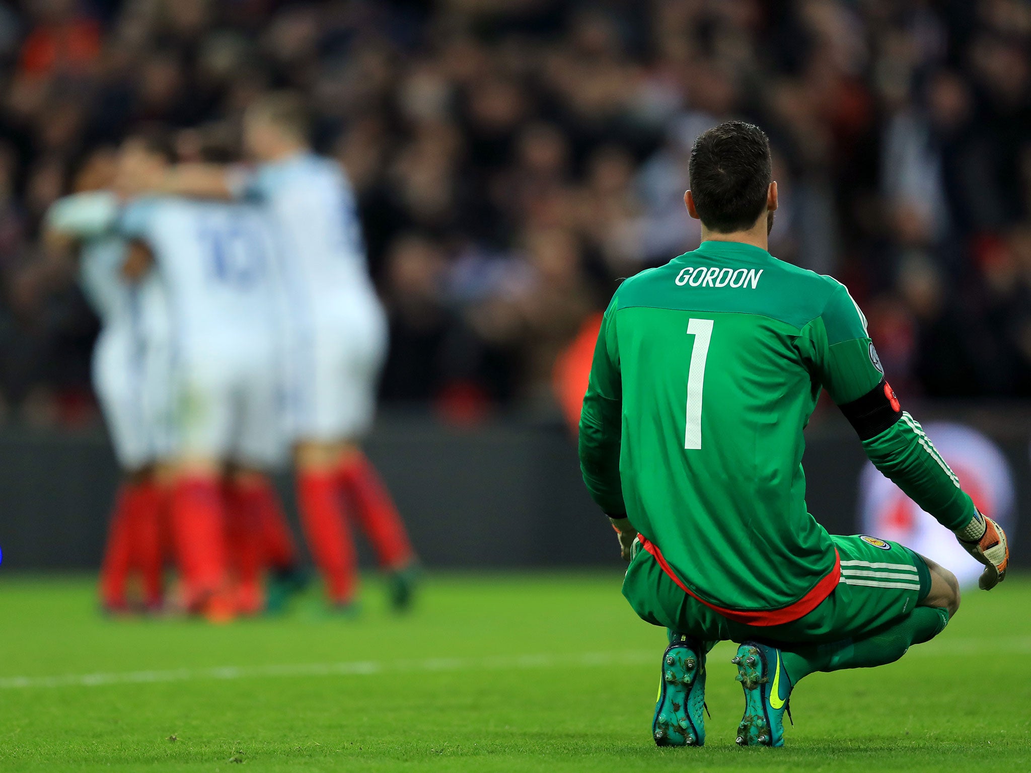 Gordon watches on as England celebrate Cahill's header