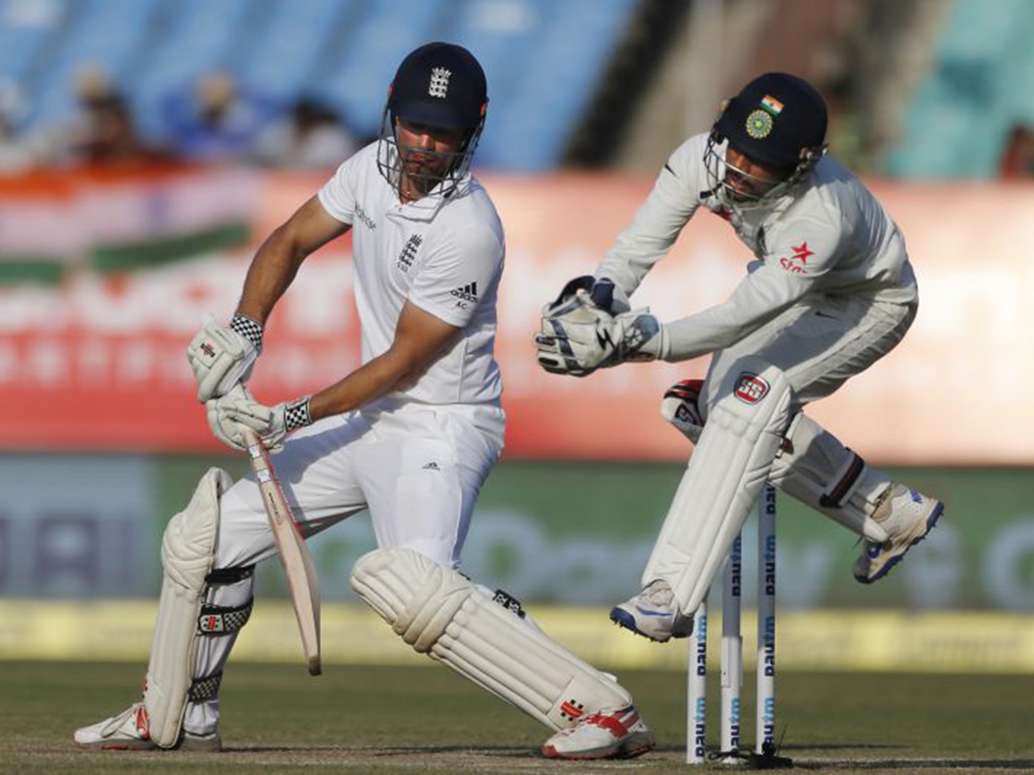 Cook plays a shot as Saha attempts to steal the ball