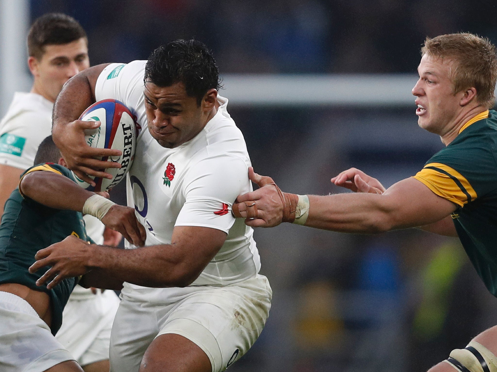 Vunipola, centre, breaks a tackle at Twickenham