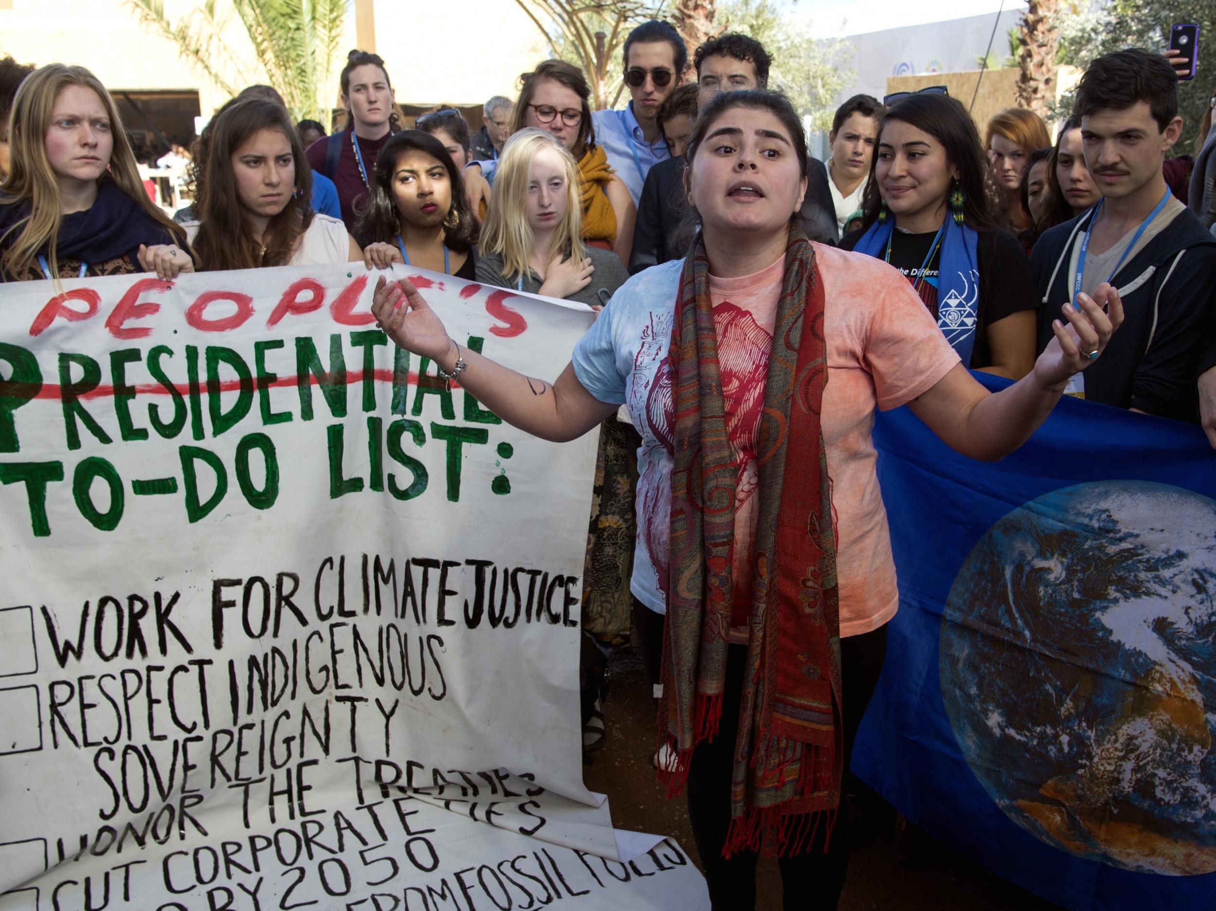 American students protest outside the UN climate talks during the COP22 international climate conference in Marrakesh in reaction to Donald Trump's victory in the US presidential election, on November 9, 2016.