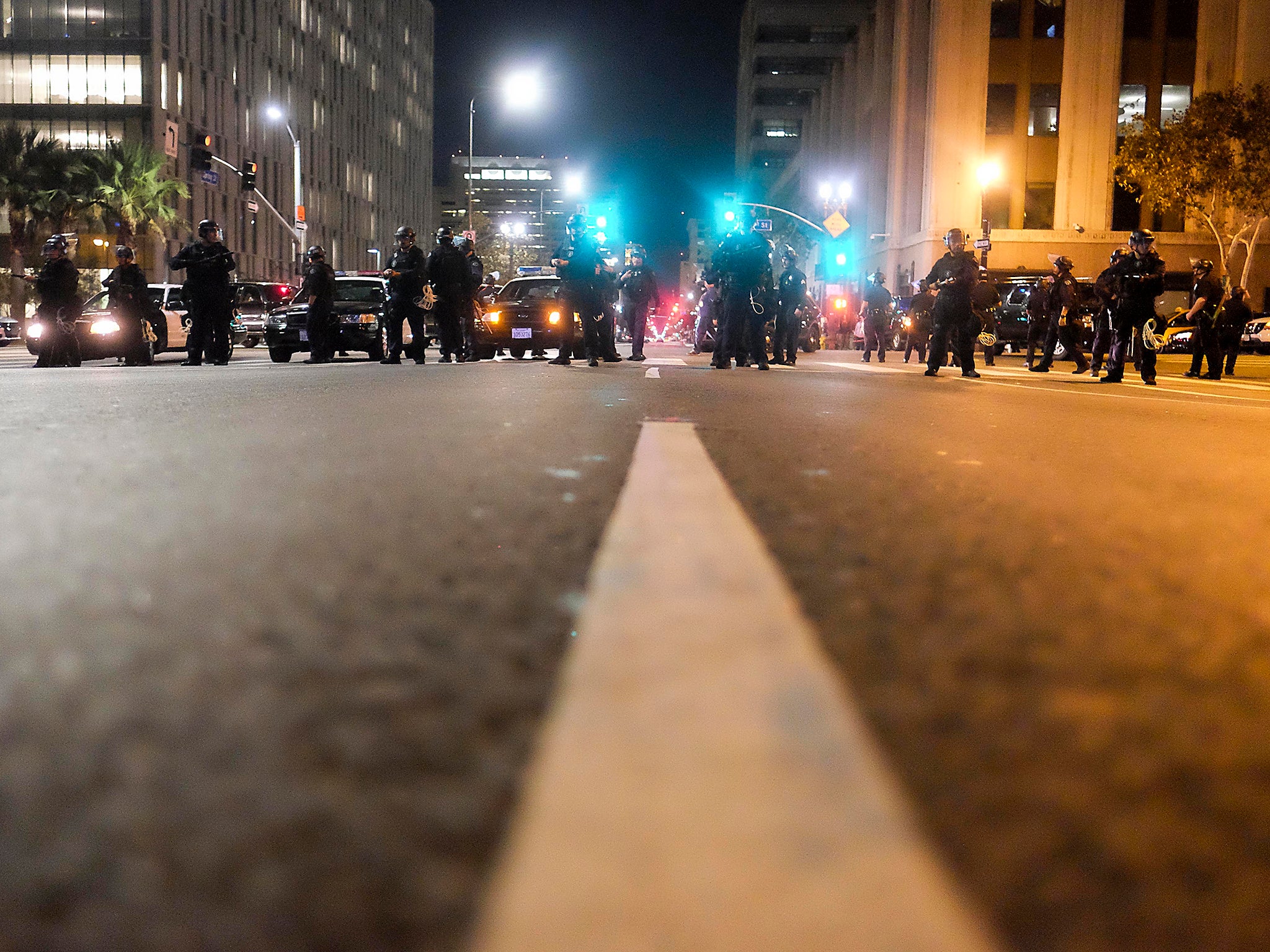 Police in riot gear stand guard outside City Hall during a protest against US President-elect Donald Trump in Los Angeles, California