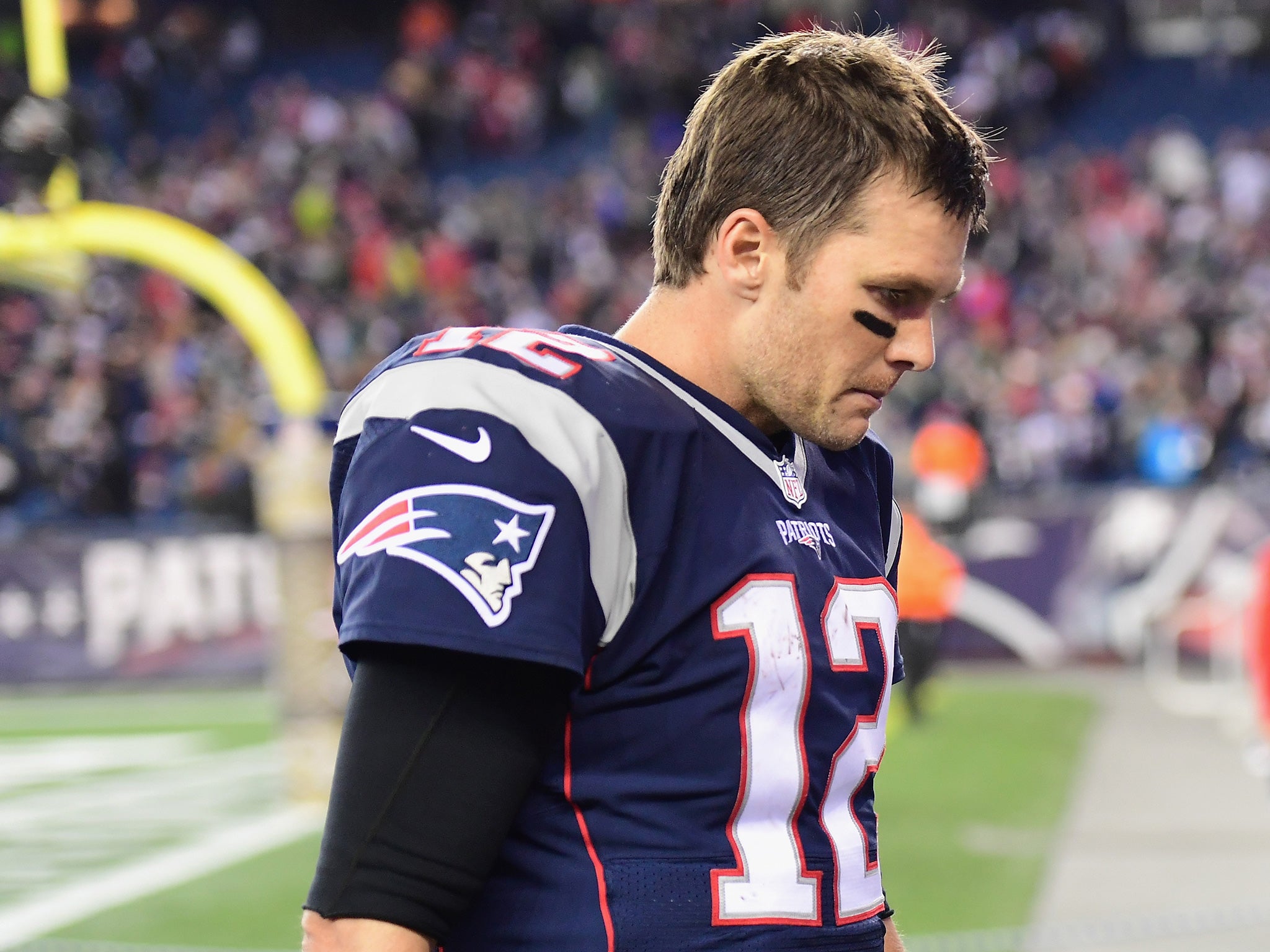 Brady walks off the field at the Gilette Stadium after the Patriots' defeat