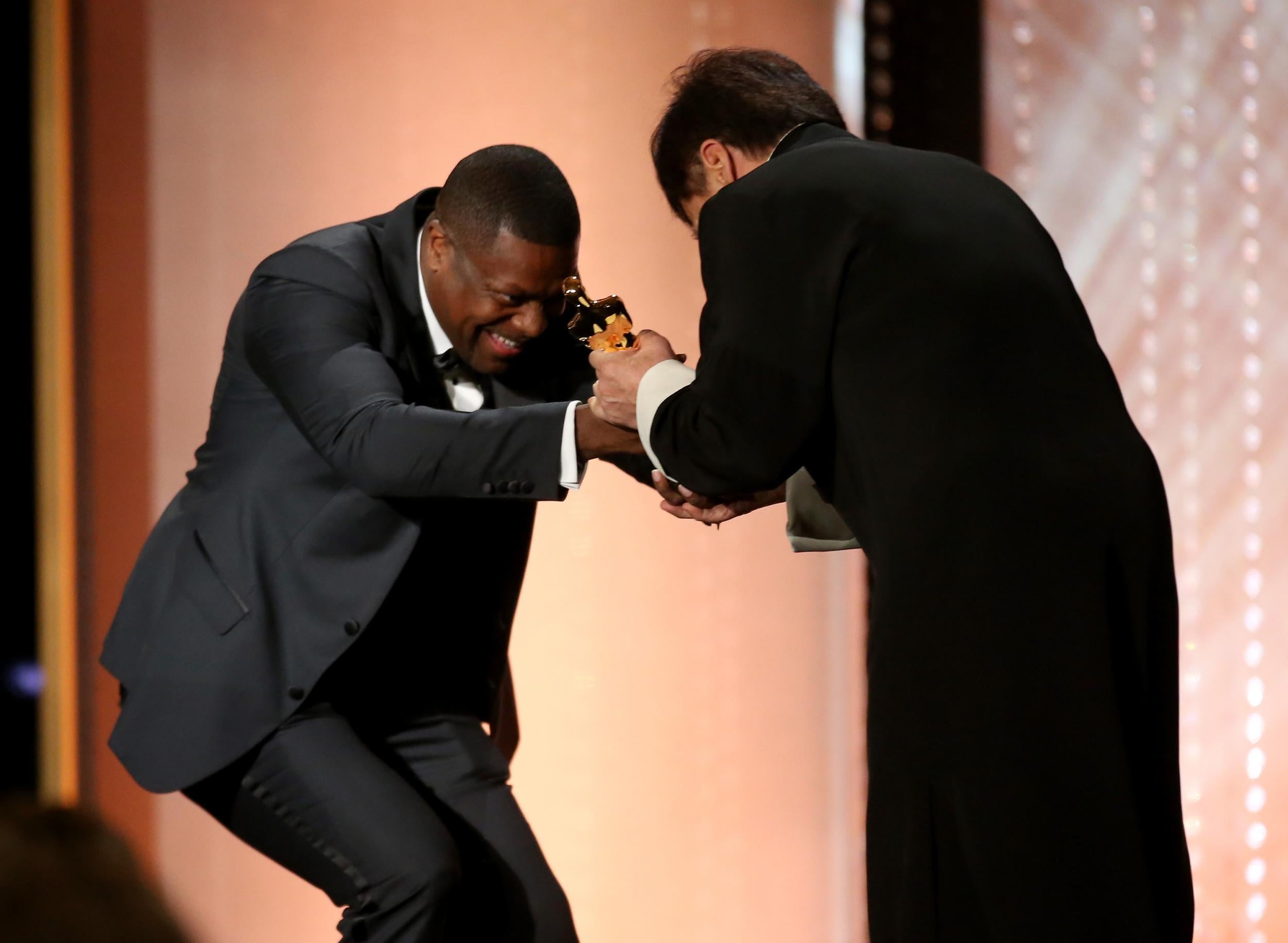 Chris Tucker presents Jackie Chan with his award (Pic: Getty)