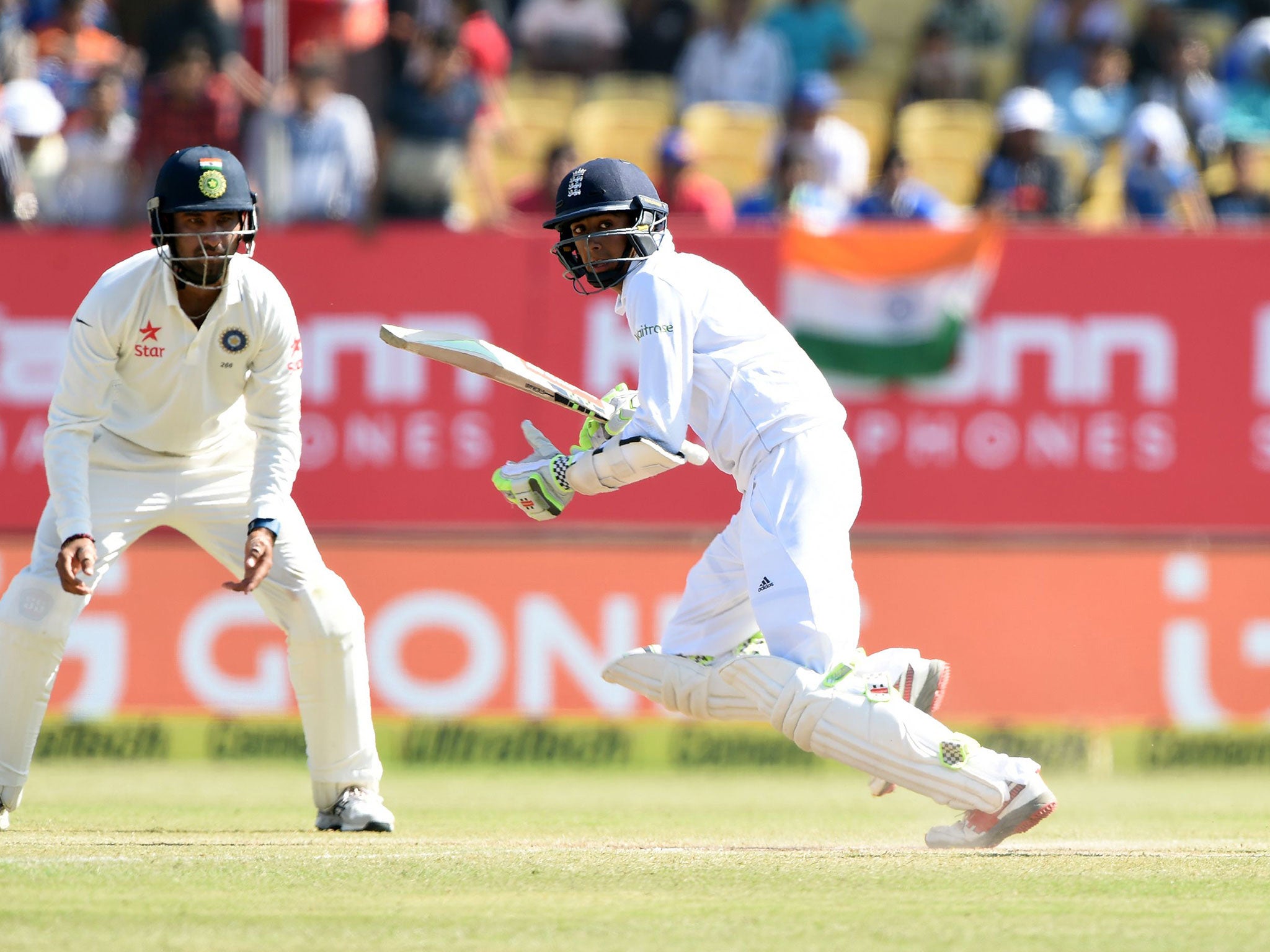 Cheteshwar Pujara (L) watches on as Haseeb Hameed plays a shot on the fifth day of the first Test cricket match between India and England