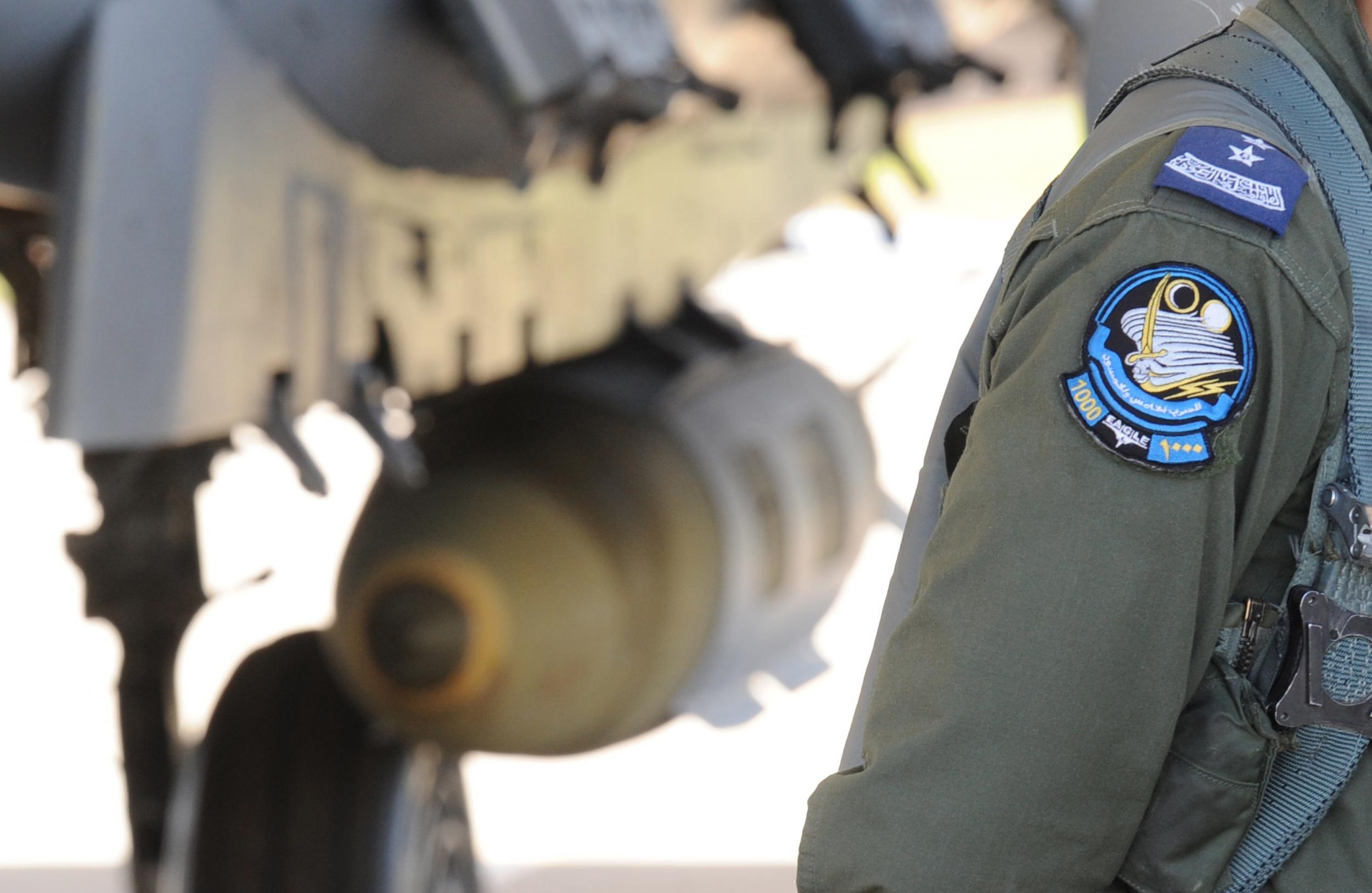 A Saudi pilot walking past a F-15 fighter jet at the Khamis Mushayt military airbase, some 880 km from the capital Riyadh