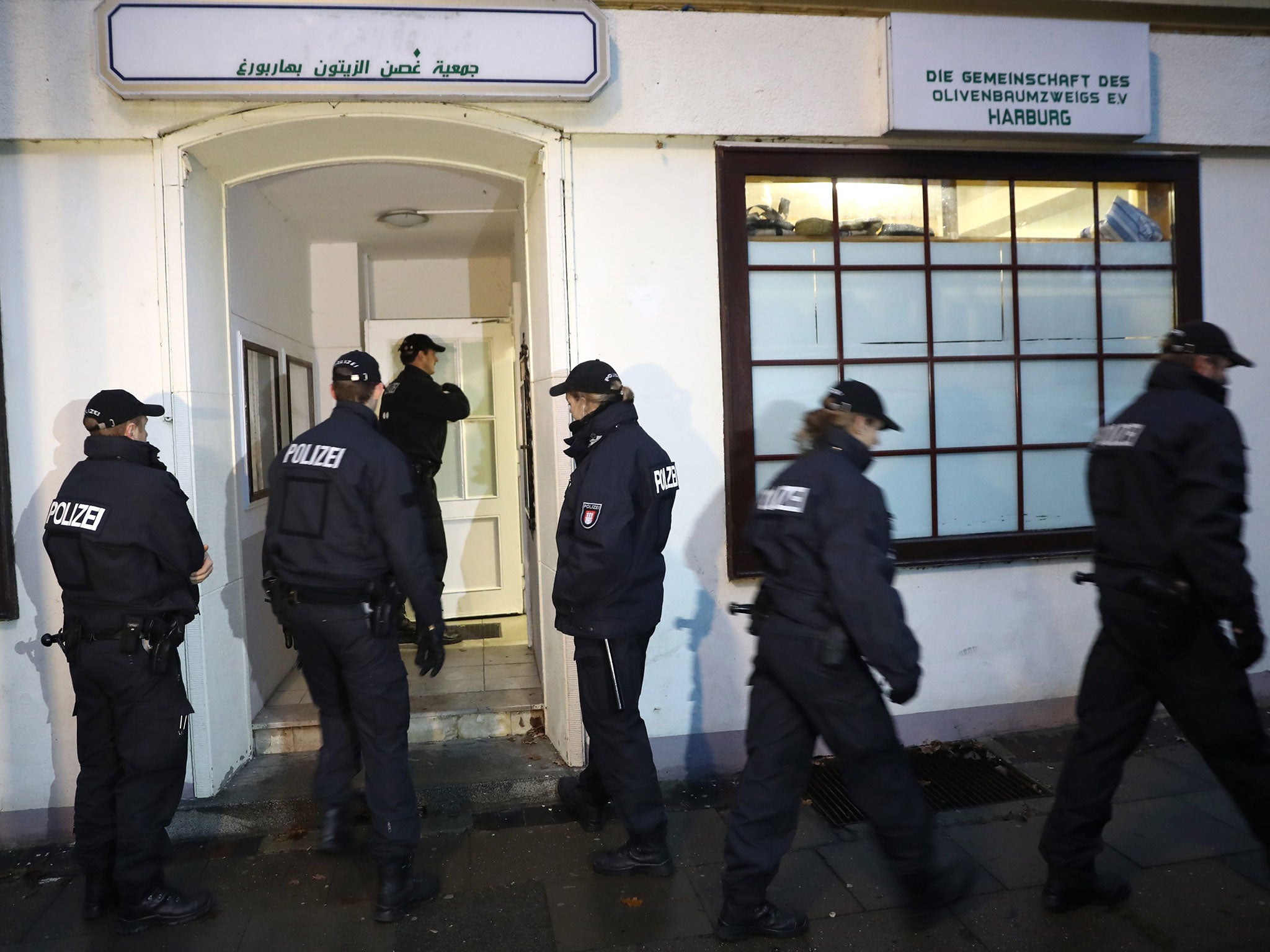 Police officers stand in front of the Al-Taqwa Mosque during a search in Hamburg, Germany, 15 November 2016.