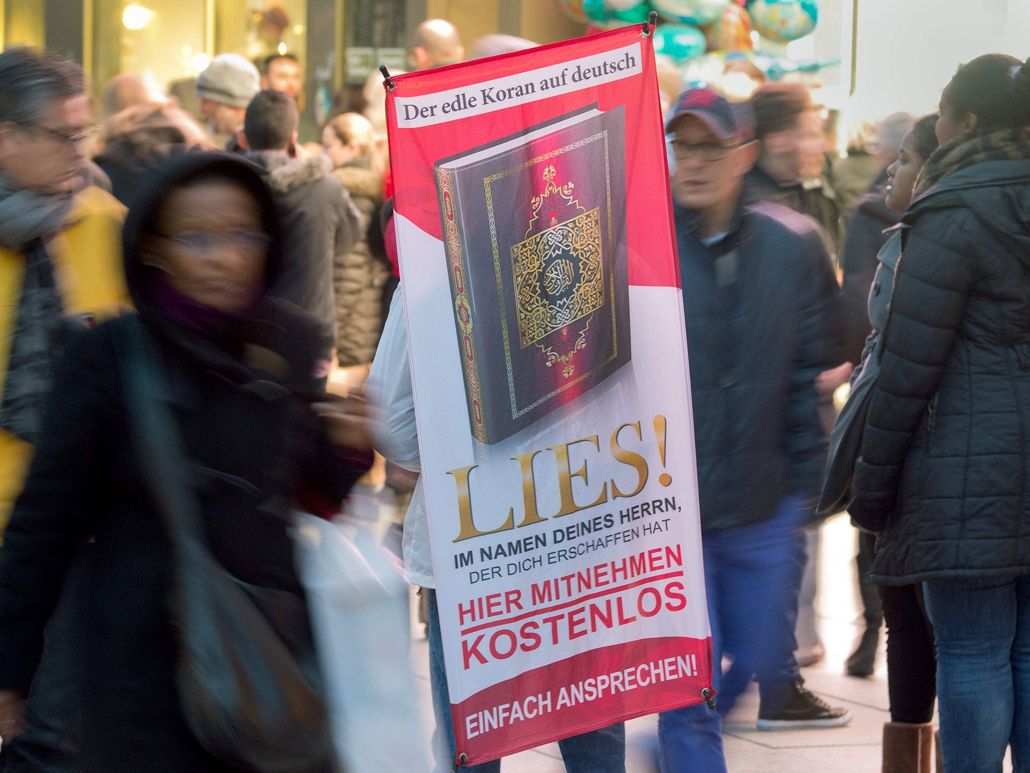 A person distributing translations of the Quran as part of the banned Die Wahre Religion group's Lies! campaign in Frankfurt am Main, Germany, in 2015 (AFP/Getty Images)