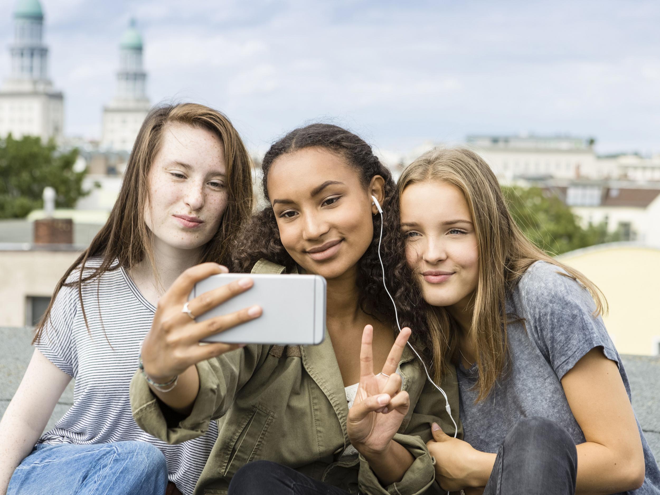 A group of teenagers pose for a selfie. Blood plasma taken from young people could help rejuvenate the brain and other organs of the elderly