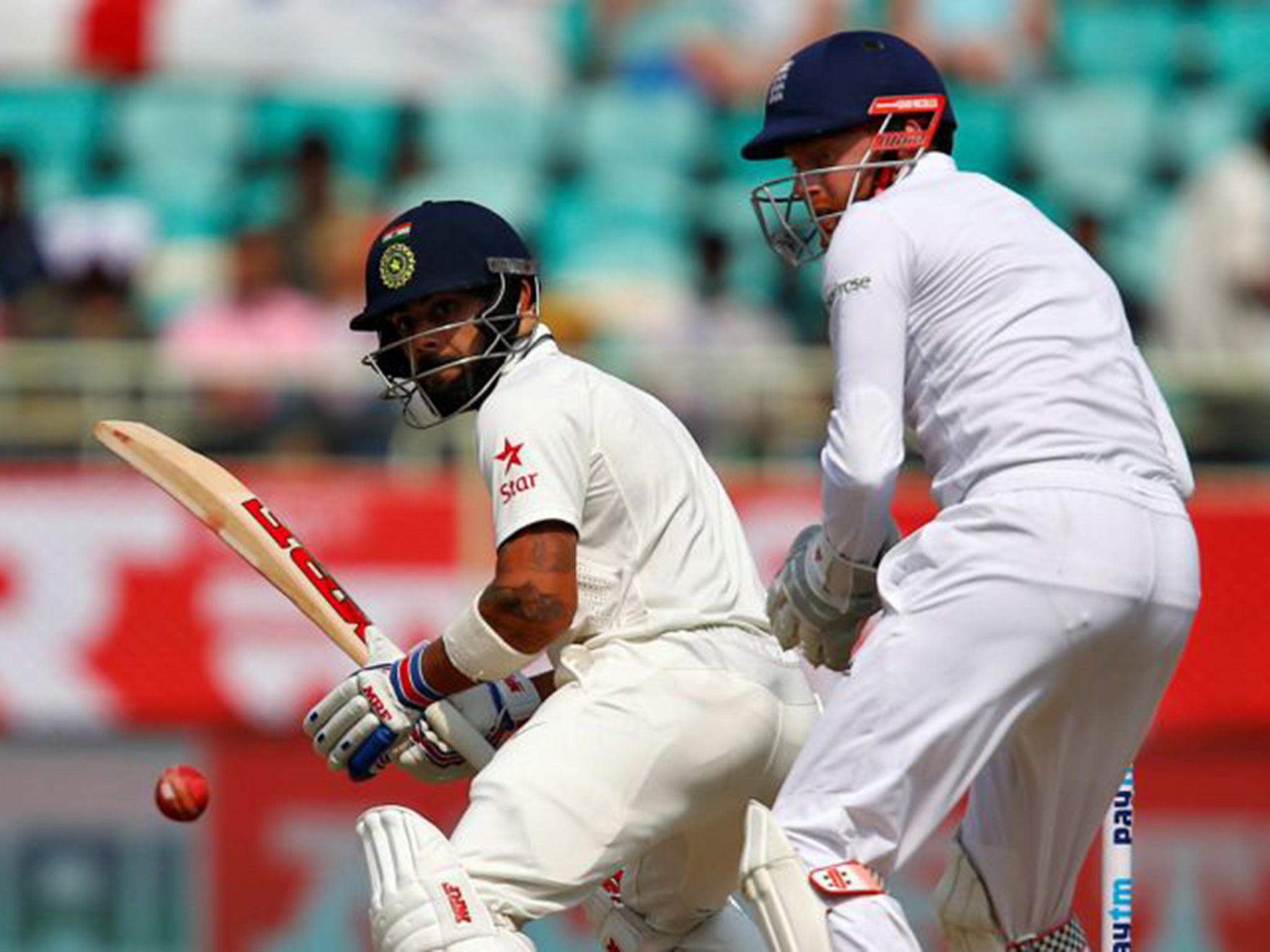 Kohli plays a shot past England's wicketkeeper Bairstow