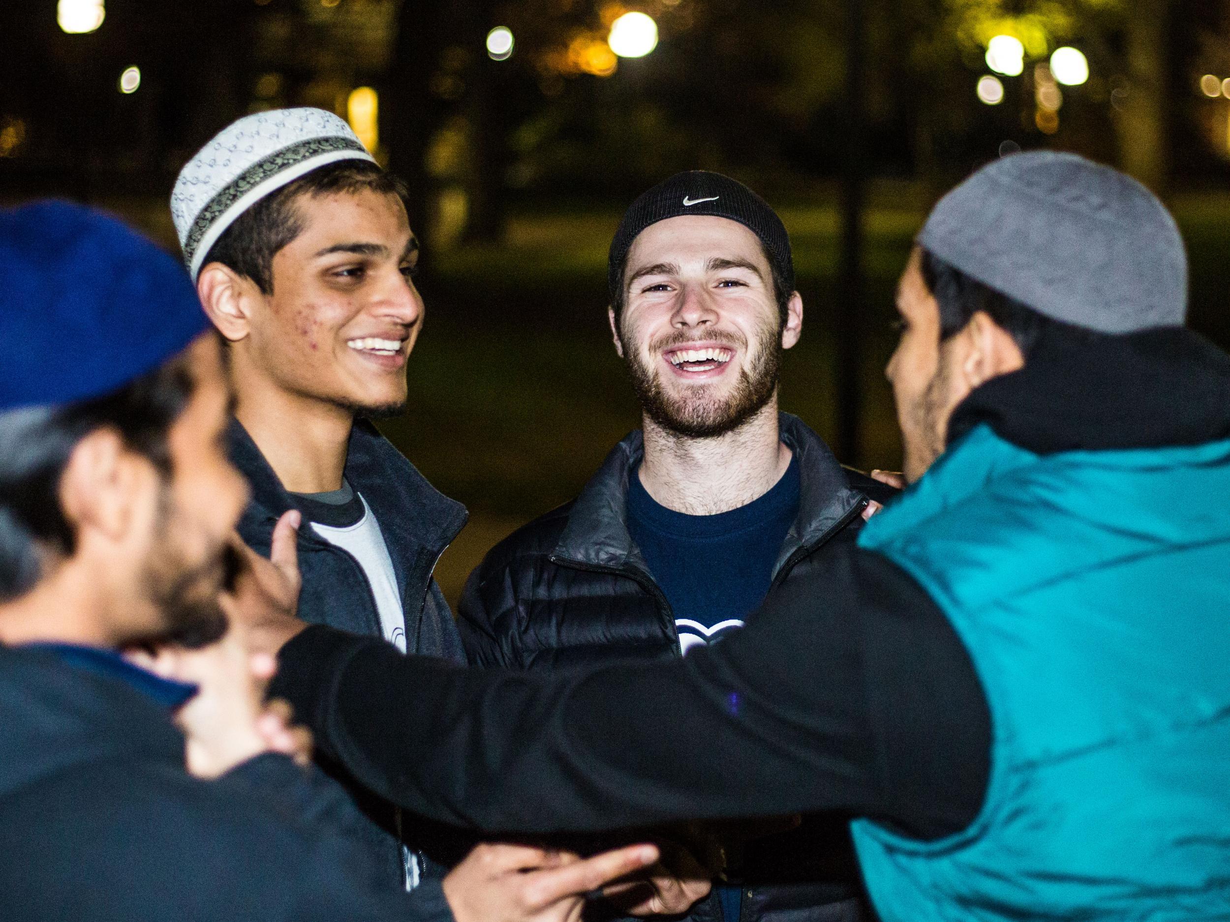 Muslim and non-Muslim University of Michigan students chat after a group prayer