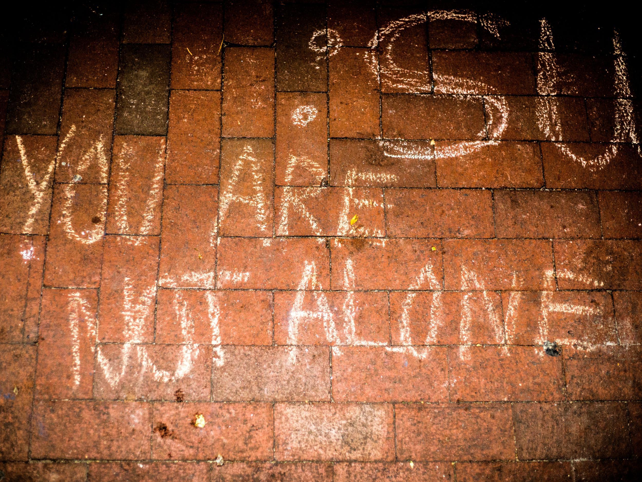 Chalk left on the ground after students turn out in support of Muslim classmates holding public prayers