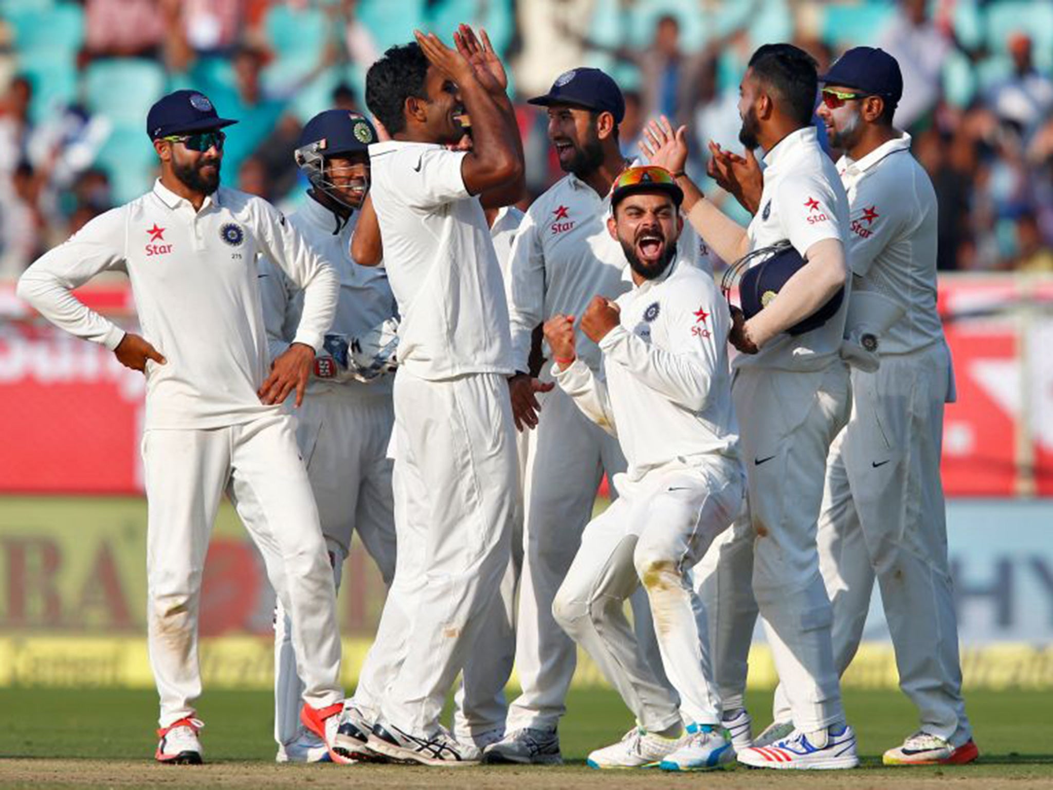India's players celebrate a successful day with the ball