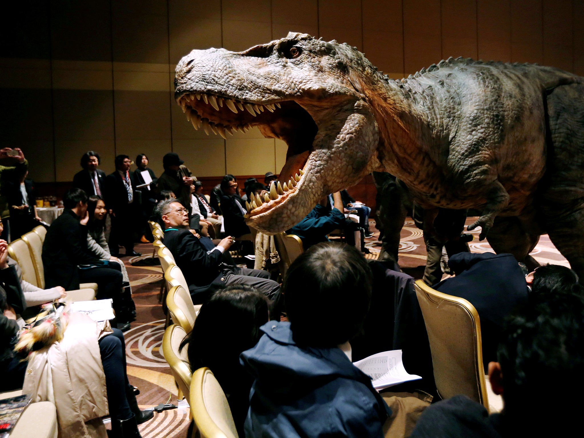 Japan's On-Art Corp's eight metre tall dinosaur-shaped mechanical suit robot 'TRX03' performs during its unveiling in Tokyo, Japan