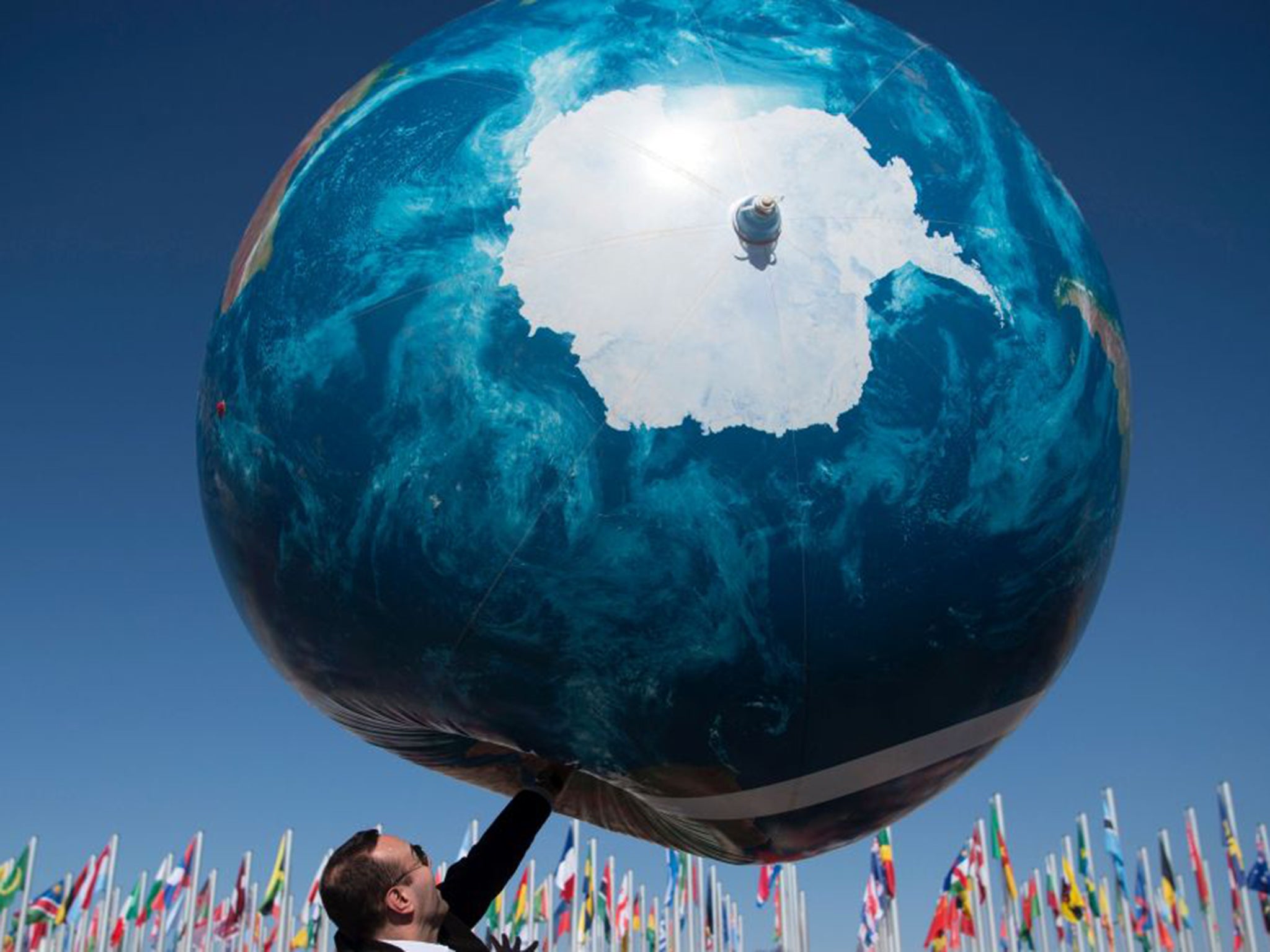 A member of the delegation plays with a giant air globe outside the COP22 climate conference in Marrakesh yesterday