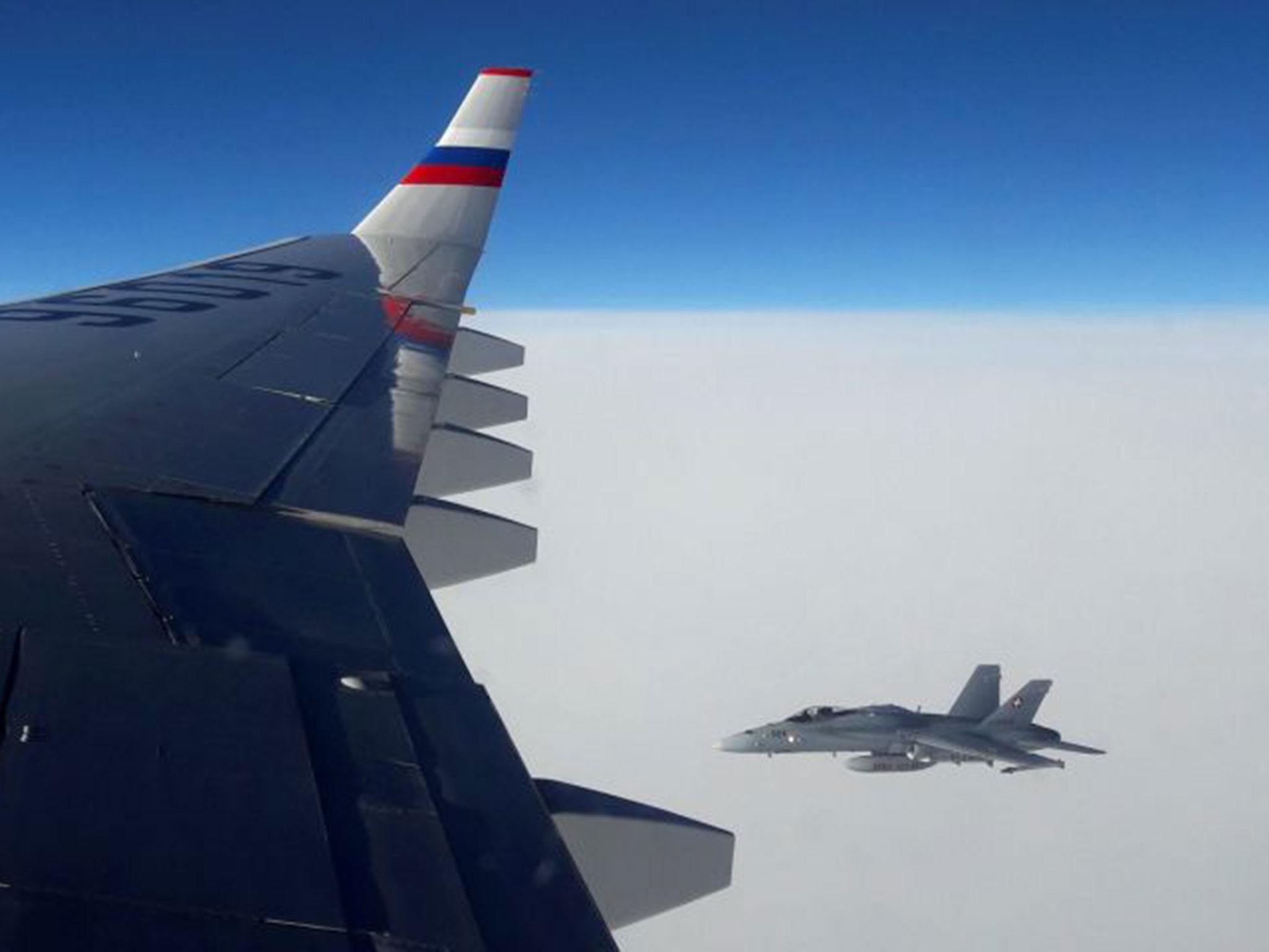 A view from the Russian plane, showing a Swiss Air Force F/A-18 fighter jet in the airspace above Switzerland