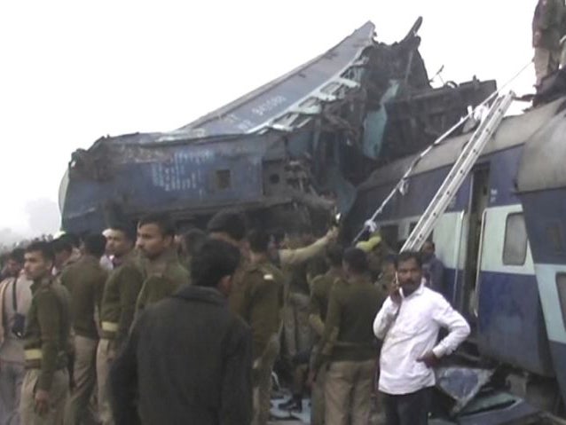 India's security forces personnel gather at the site of a train accident