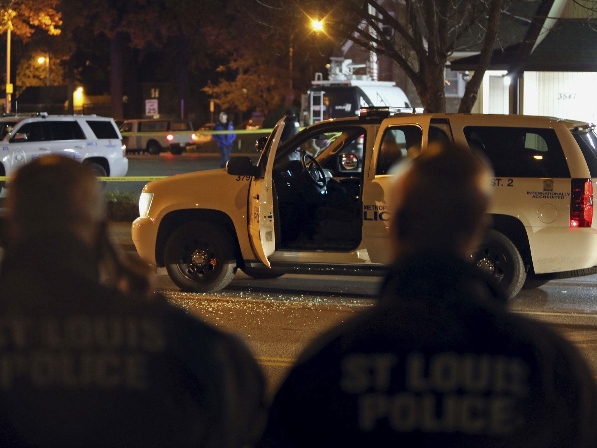 Police investigate the scene in St Louis where police officer was shot in what the police chief called an 'ambush' on Sunday, 20 November, 2016