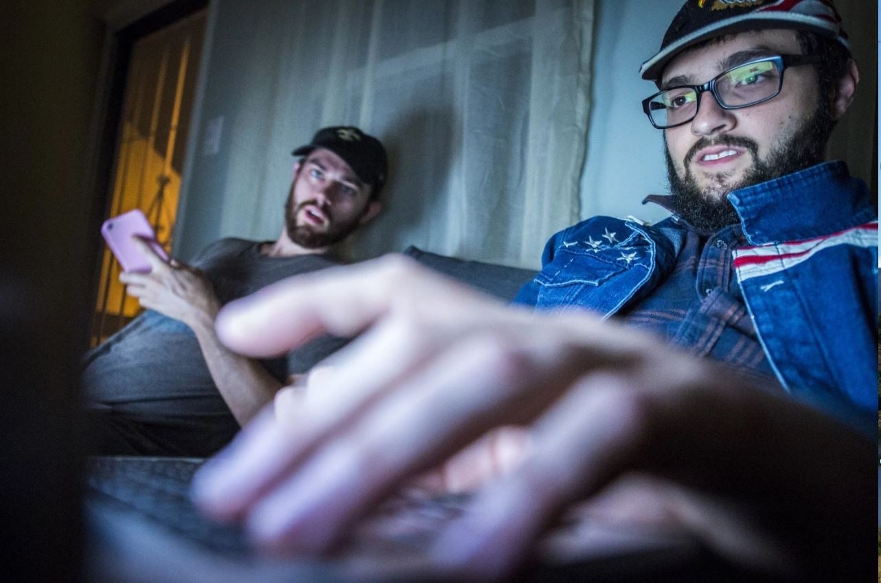 At their apartment in Long Beach, Calif., Paris Wade, left, and Ben Goldman work on their pro-Donald Trump website, LibertyWritersNews.com