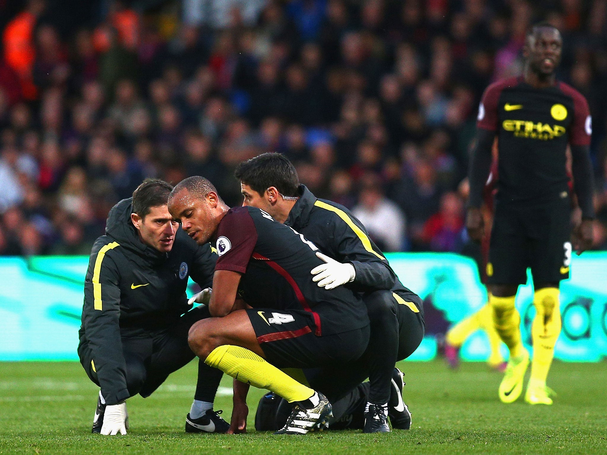 Kompany is attended to following his collision with Bravo