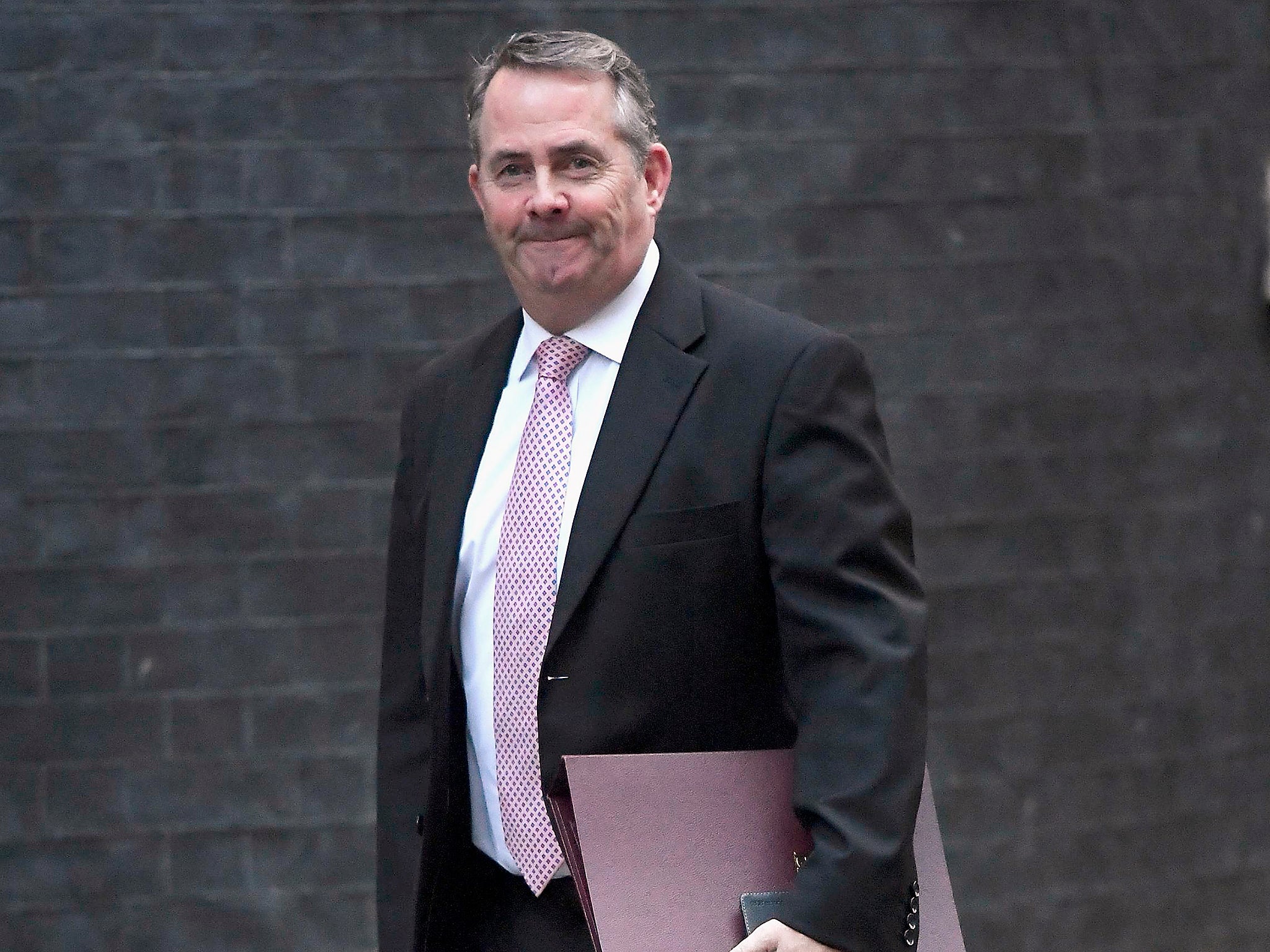 Britain's Secretary of State for International Trade Liam Fox walks into Downing Street in London