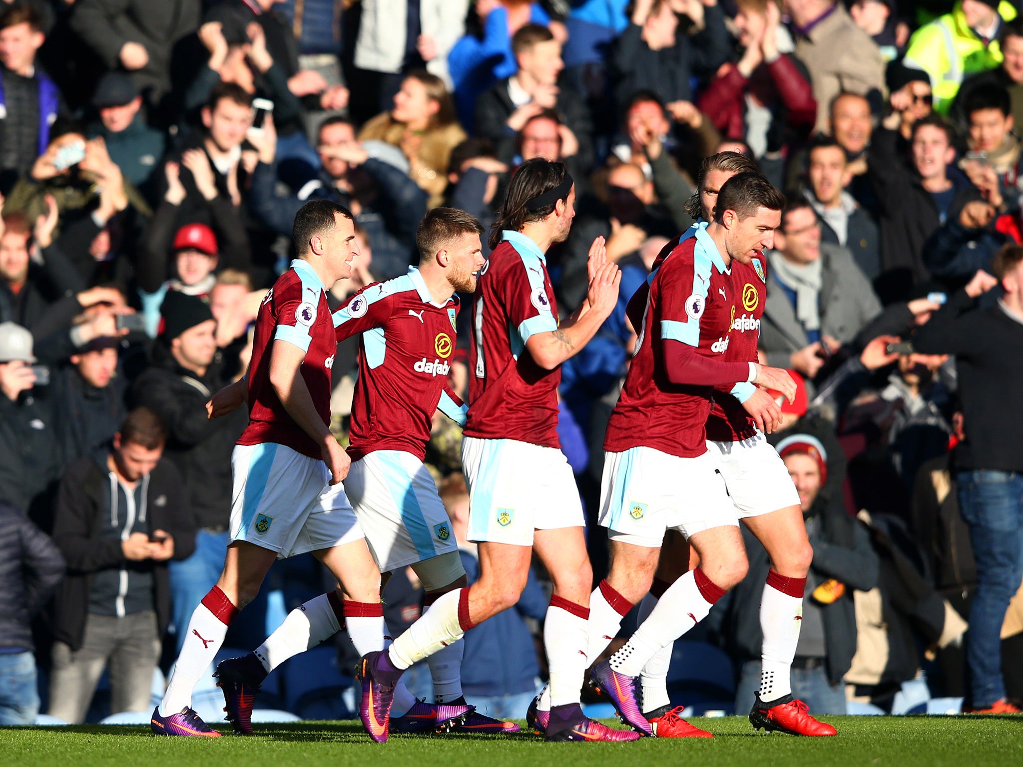 Burnley's players celebrate taking the lead through Dean Marney's strike