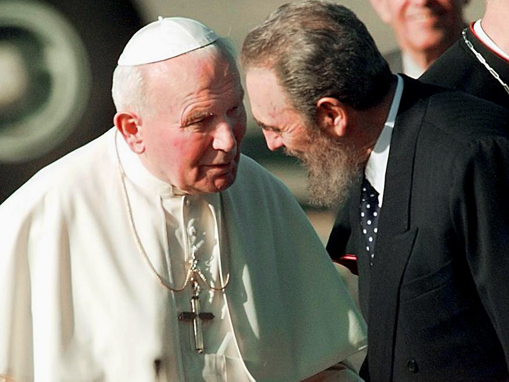 Cuban President Fidel Castro listens to Pope John Paul II as they walk on the tarmac of the Jose Marti International Airport in Havana