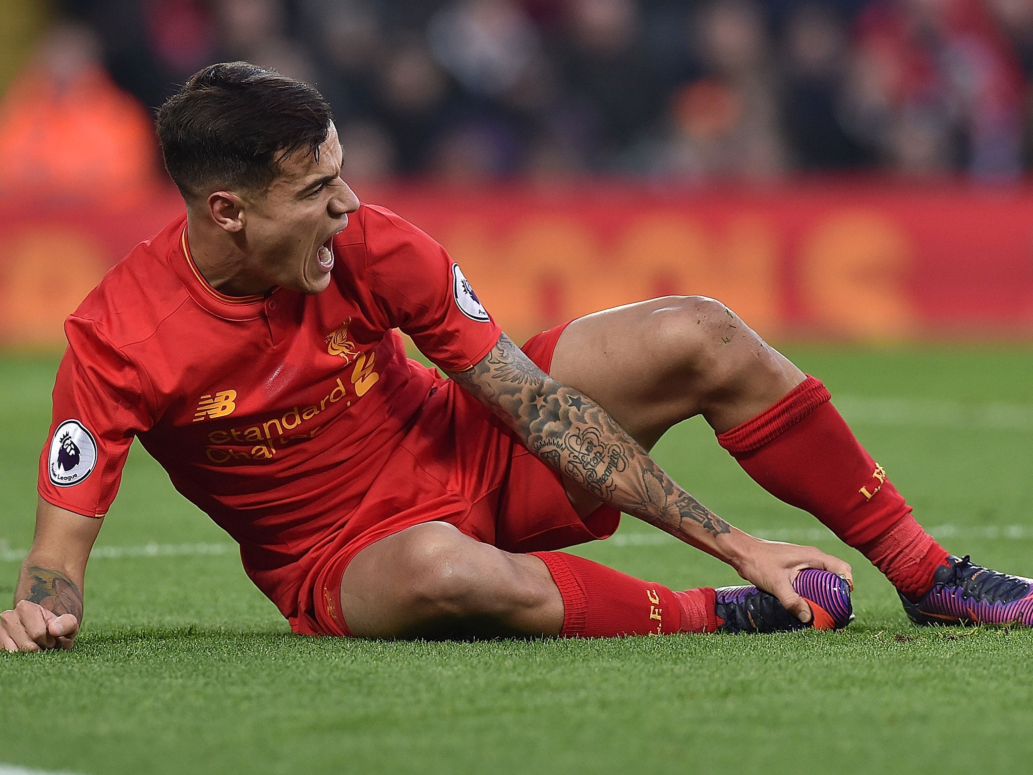 Coutinho reacts after falling awkwardly during Liverpool’s 2-0 victory over Sunderland on Saturday following a challenge by Didier Ndong