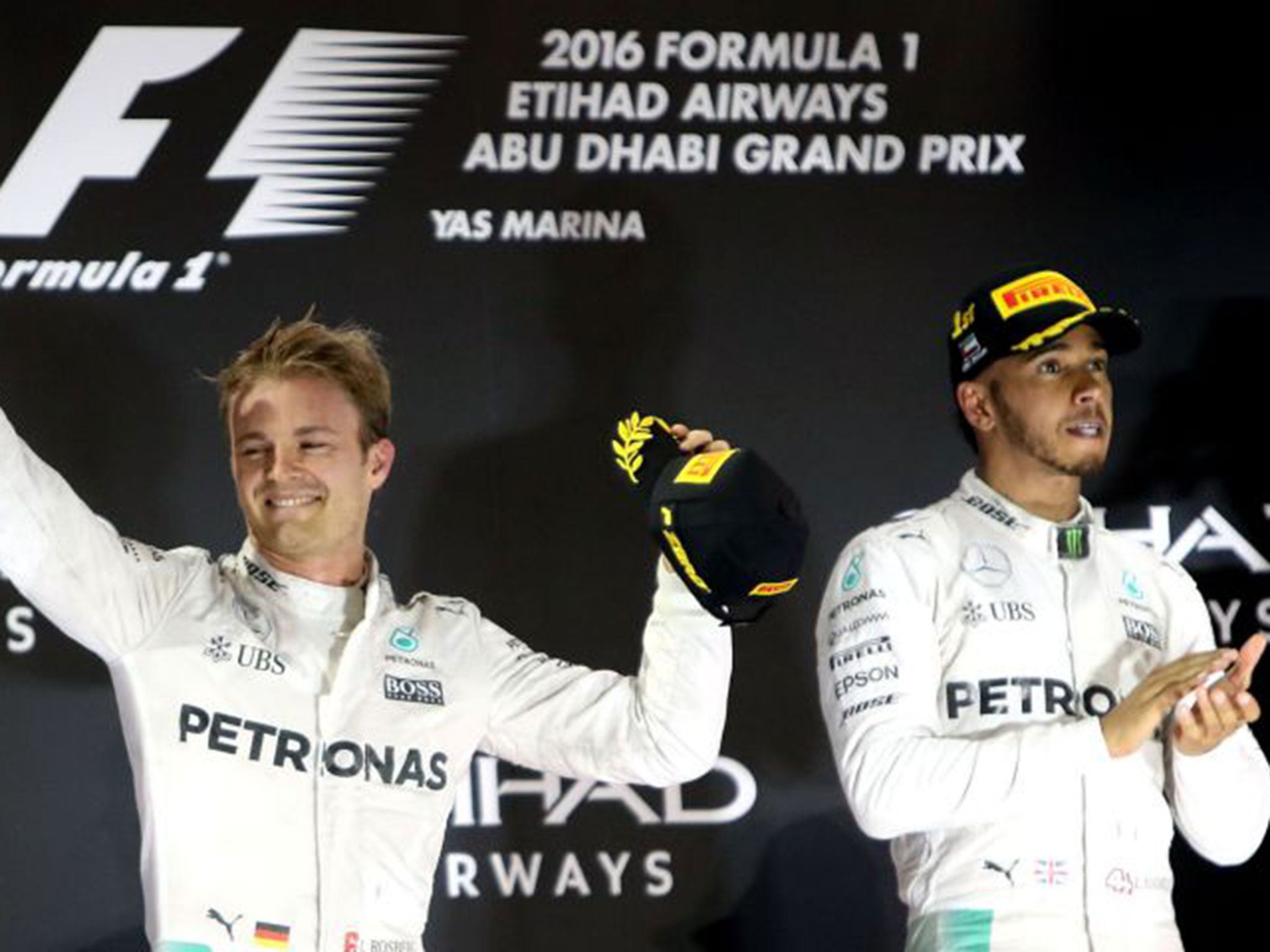 Nico Rosberg celebrates his F1 title success as Lewis Hamilton applauds