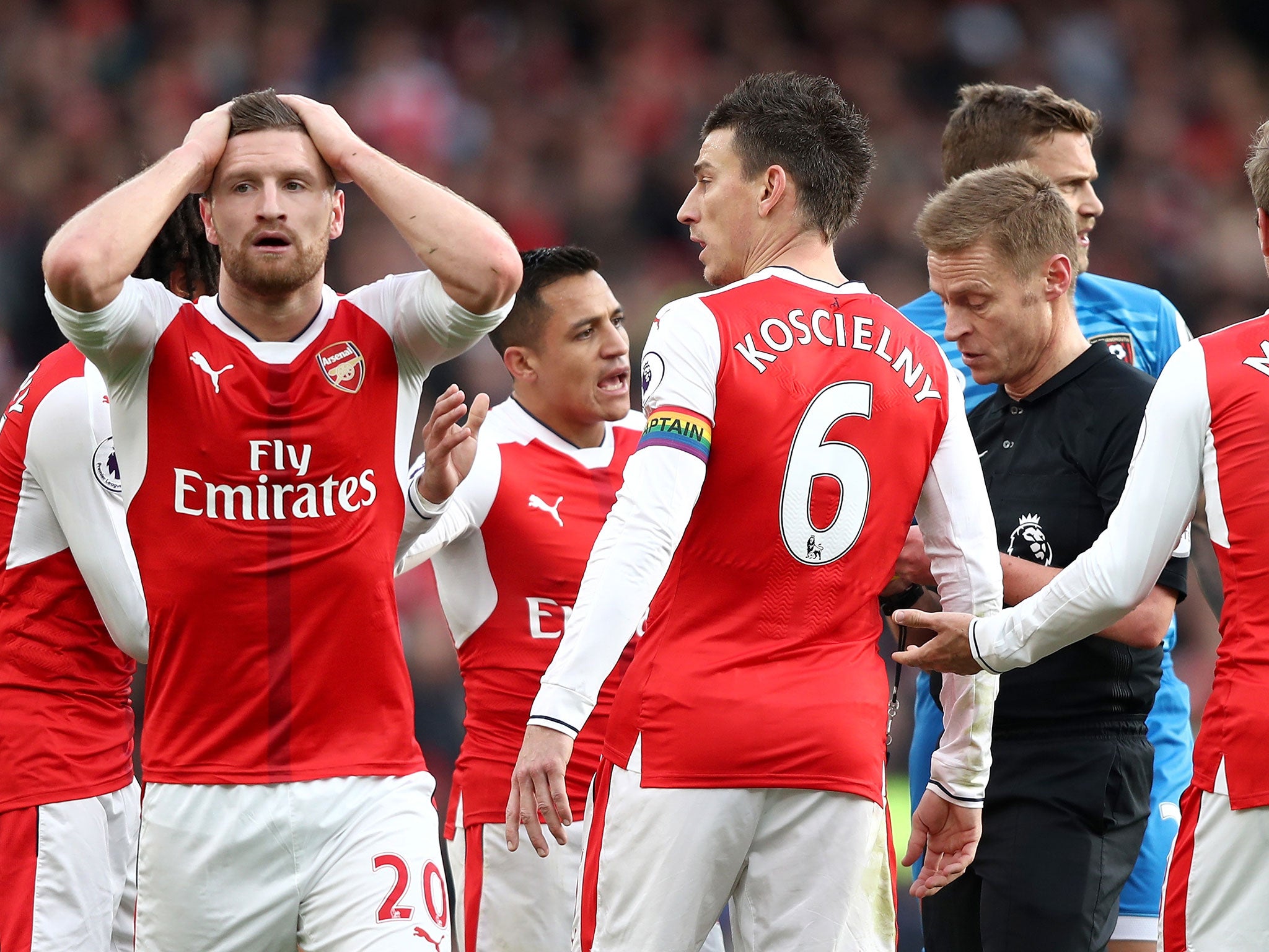 Shkodran Mustafi reacts after Nacho Monreal concedes a penalty