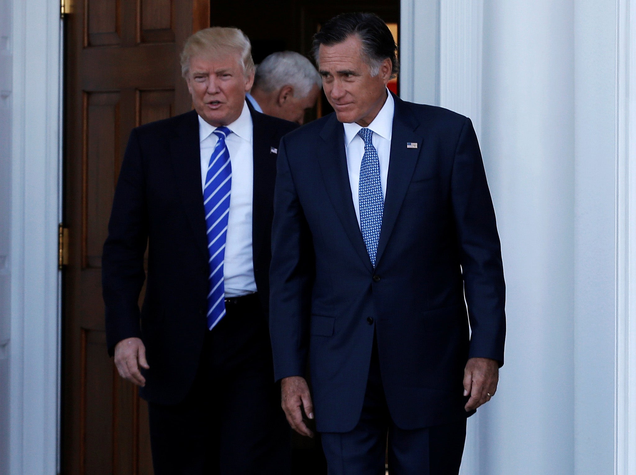 US President-elect Donald Trump (L) and former Massachusetts Governor Mitt Romney emerge after their meeting at the main clubhouse at Trump National Golf Club in Bedminster, New Jersey