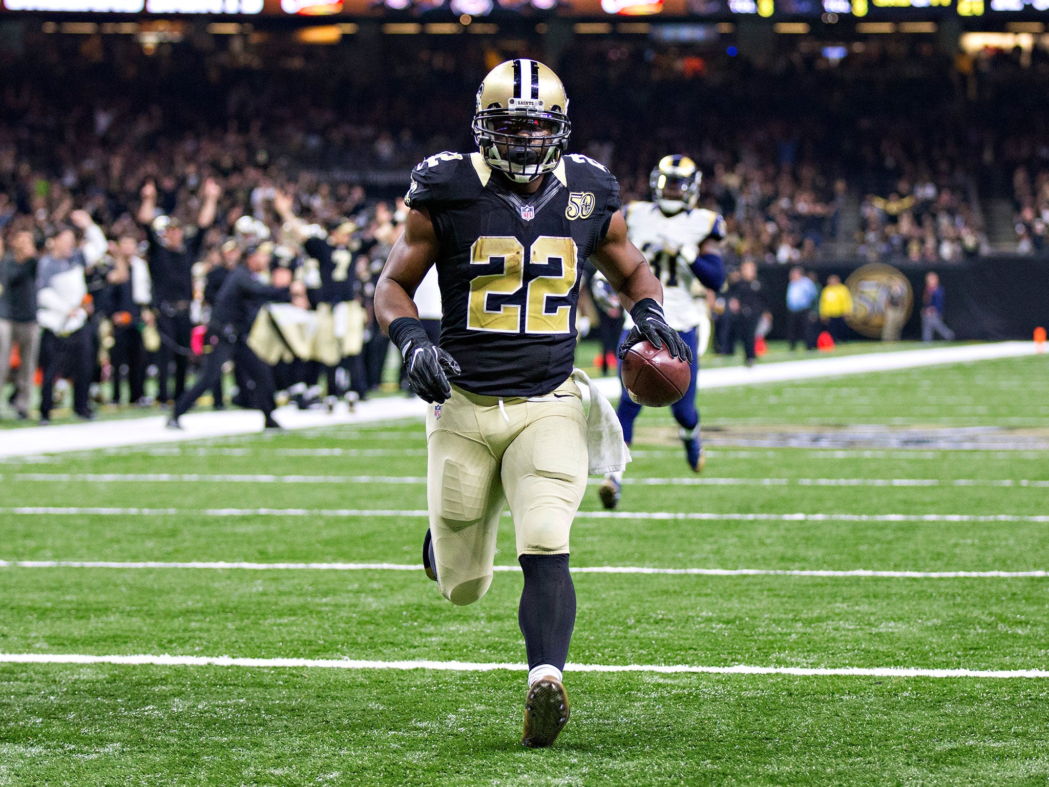 Mark Ingram #22 of the New Orleans Saints runs the ball in for a touchdown during their game against the Los Angeles Rams at Mercedes-Benz Superdome