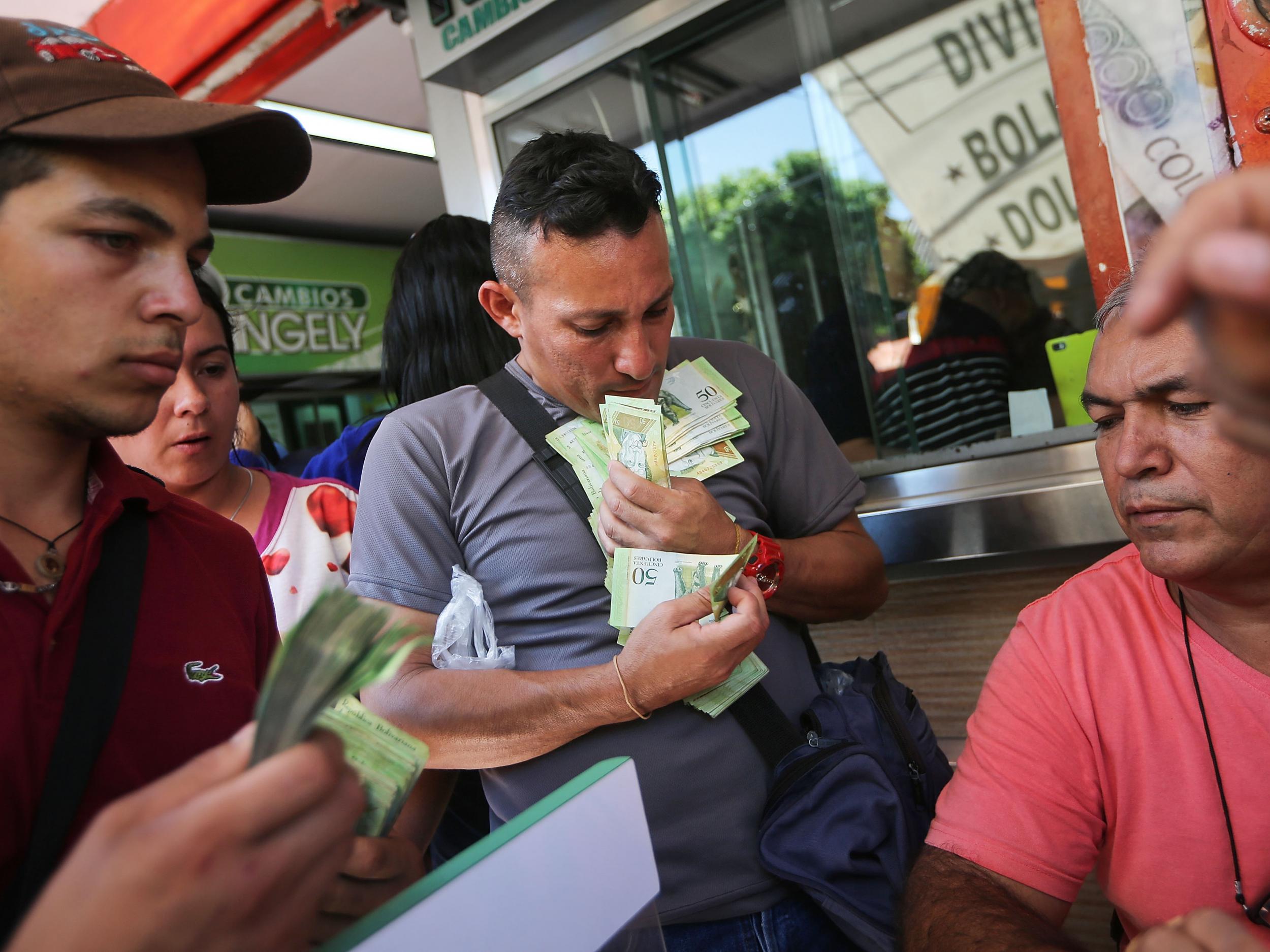 Venezuelans exchange bolivars into pesos to purchase Colombian goods