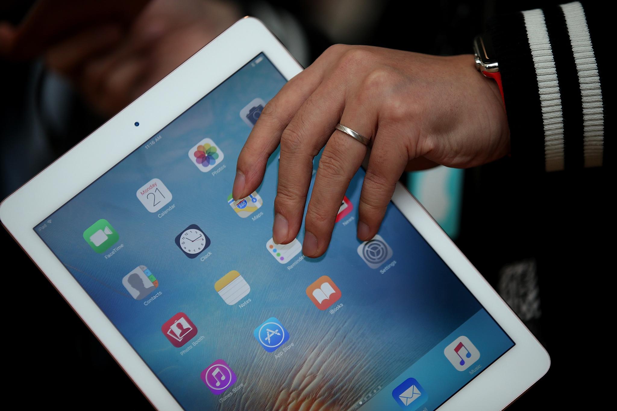 An attendee looks at the new 9.7' iPad Pro during an Apple special event at the Apple headquarters on March 21, 2016 in Cupertino, California. Apple CEO announced the iPhone SE and a 9.7' version of the iPad Pro