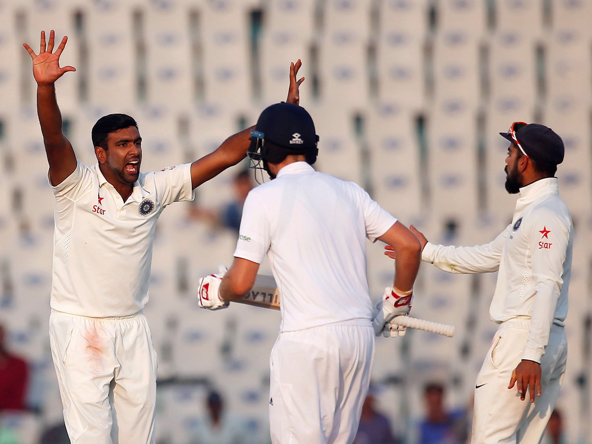 India's Ravichandran Ashwin (L) appeals successfully for the dismissal of England's Ben Stokes on the fourth day of the Third test