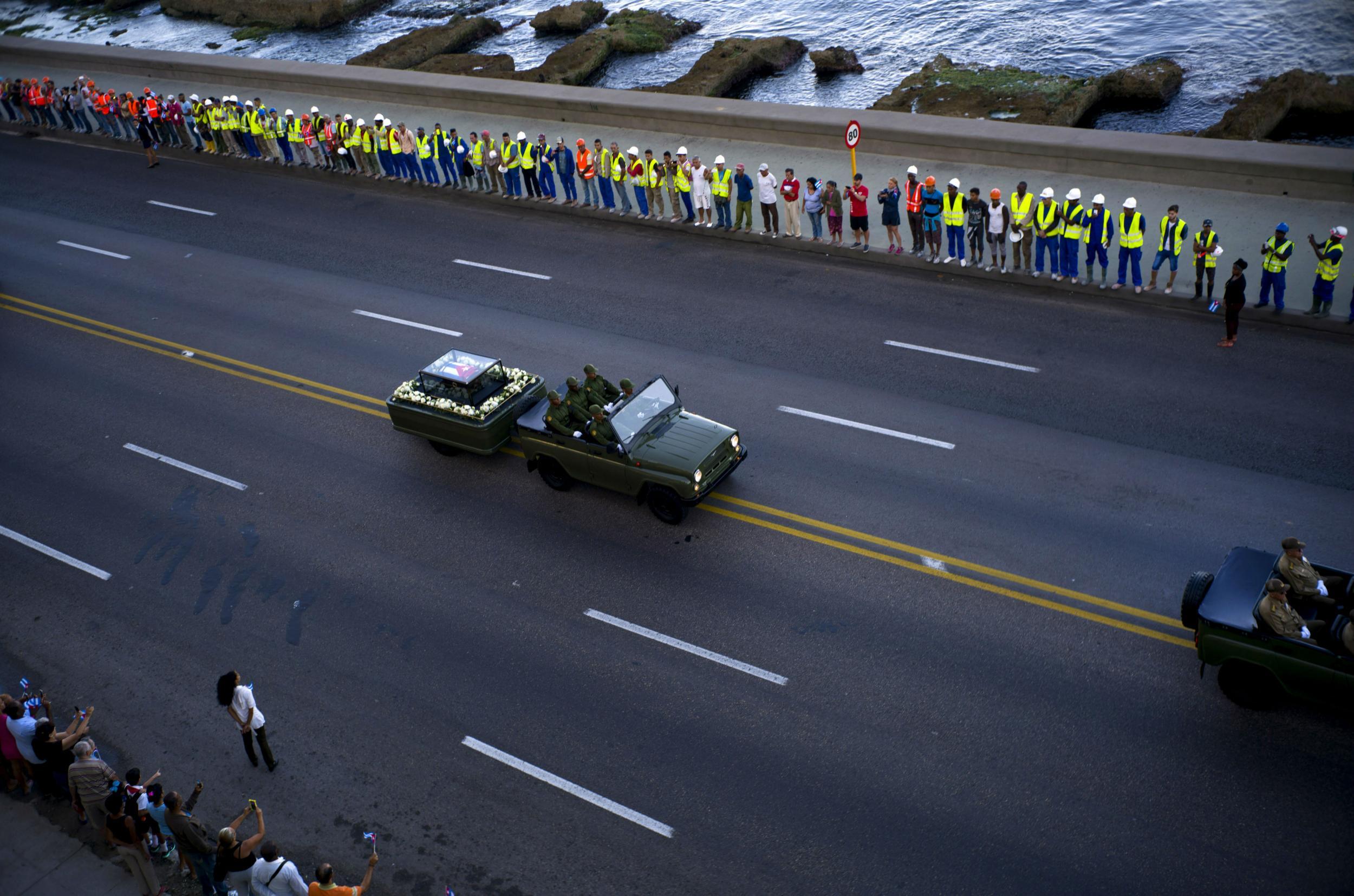 The simple cortege on the Malecon, the flatbed trailer fringed with flowers