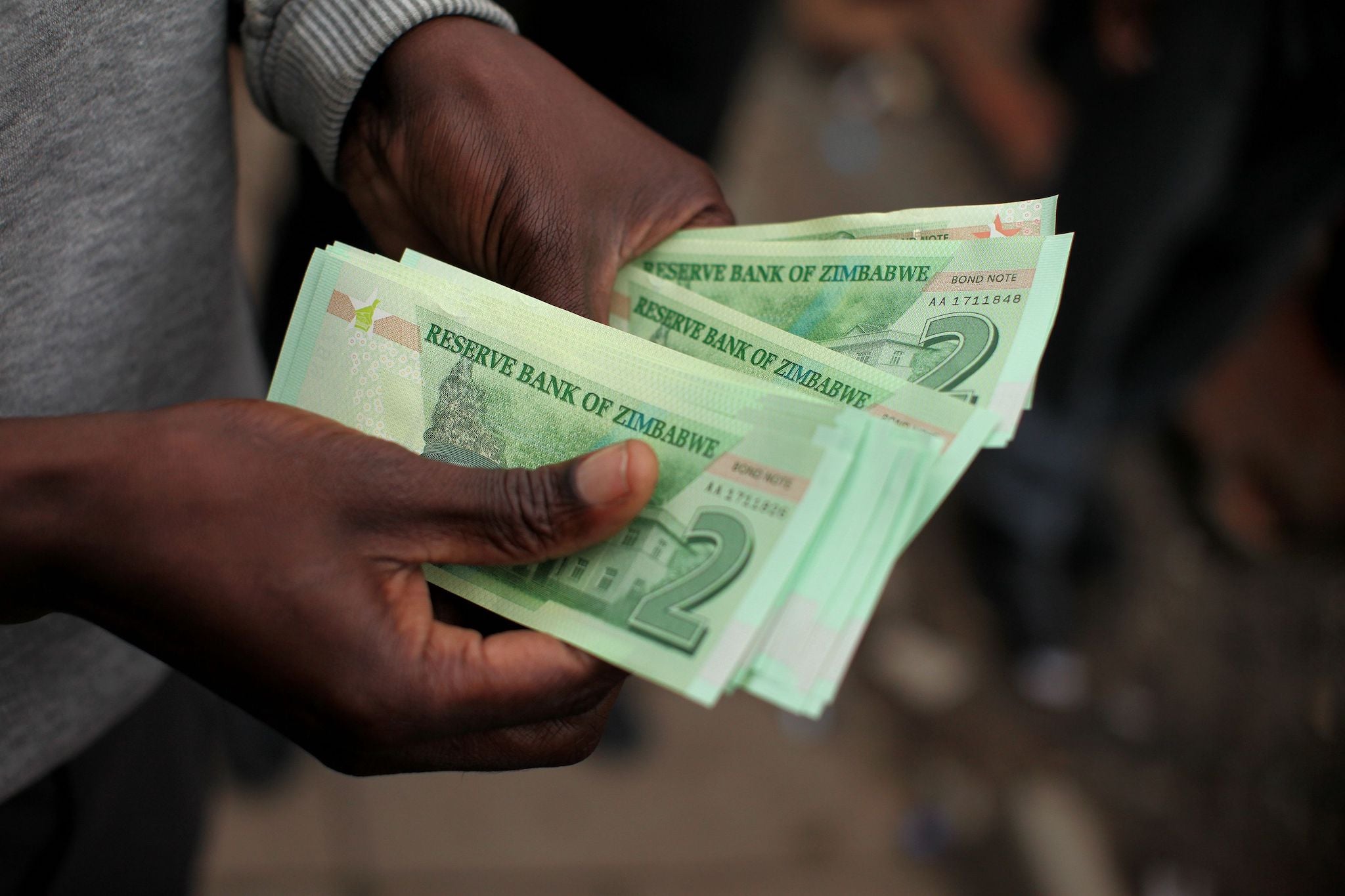 A man holds bond notes released by the Reserve Bank Of Zimbabwe in Harare central business centre on November 28, 2016