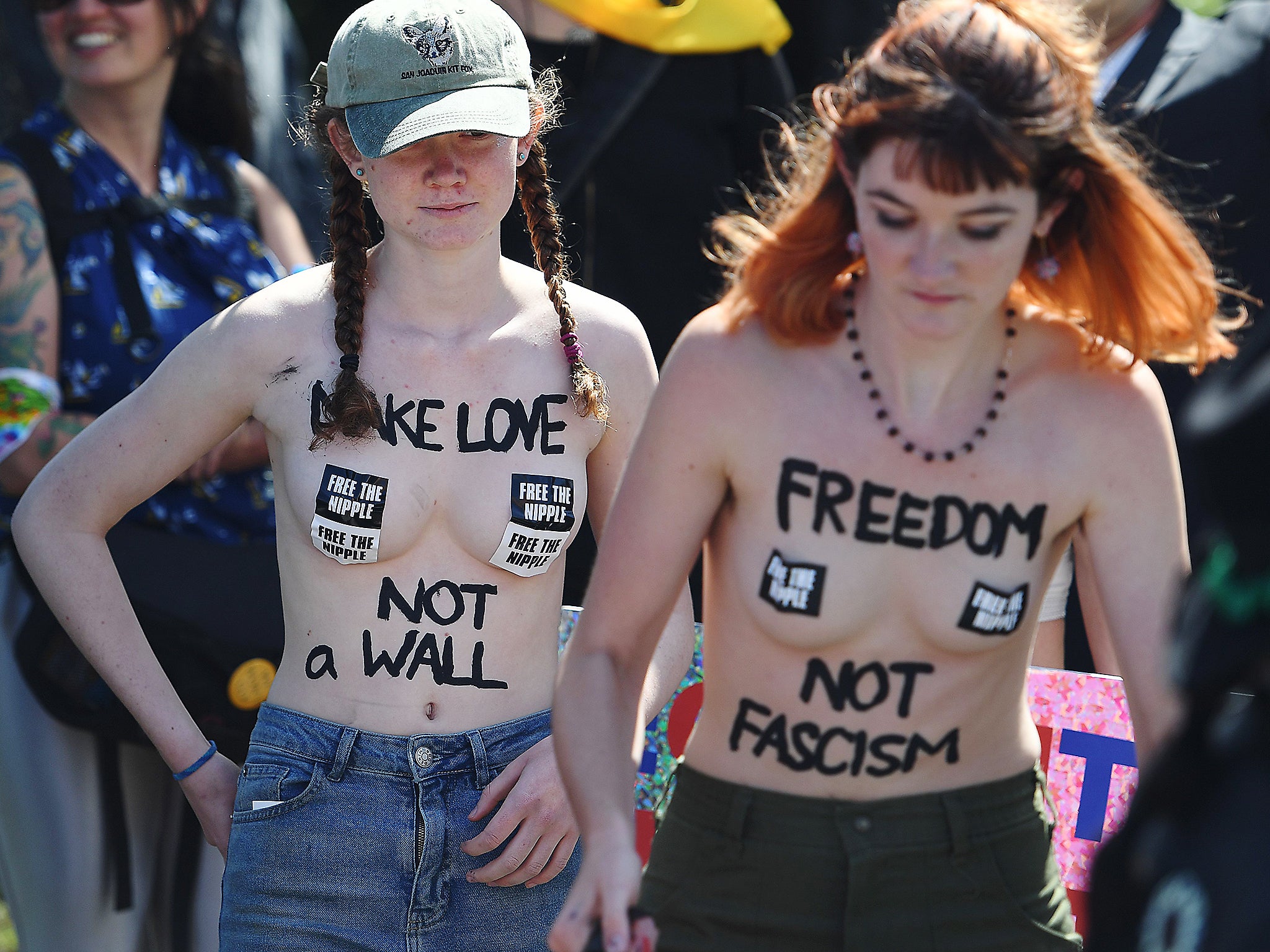 Topless protesters participate in an anti-Trump rally outside the Hyatt Regency Hotel where republican presidential candidate Donald Trump was speaking in Burlingame, California on April 29, 2016