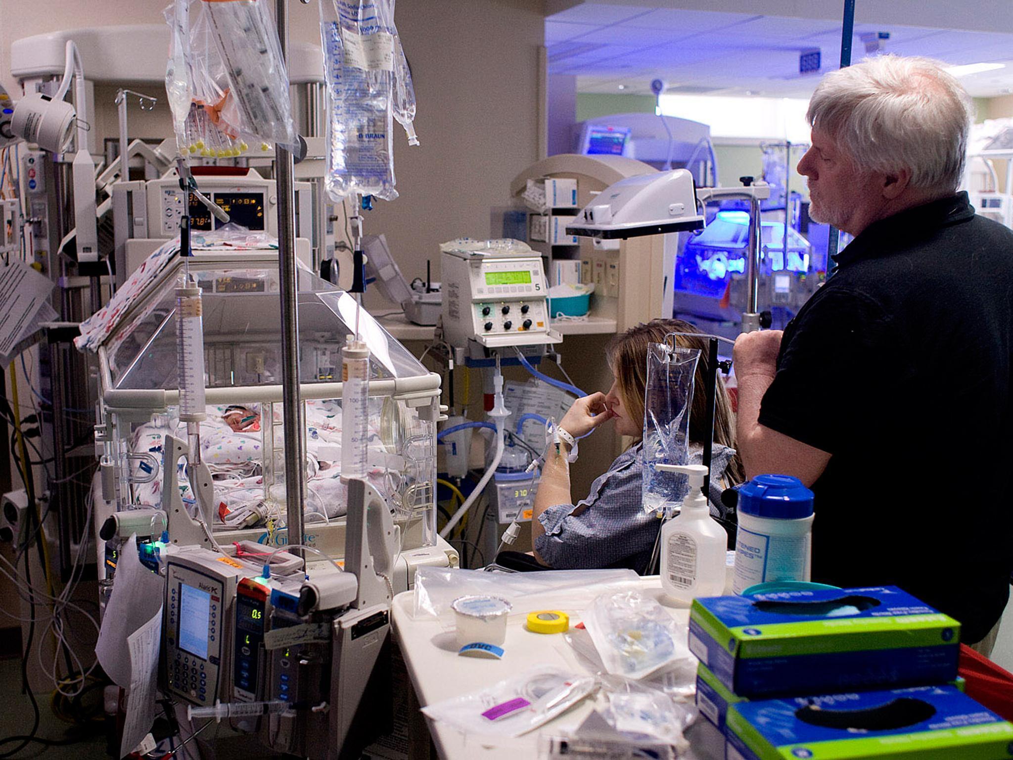 Kelley and Tom French beside the incubator of their daughter Juniper, born at 23 weeks