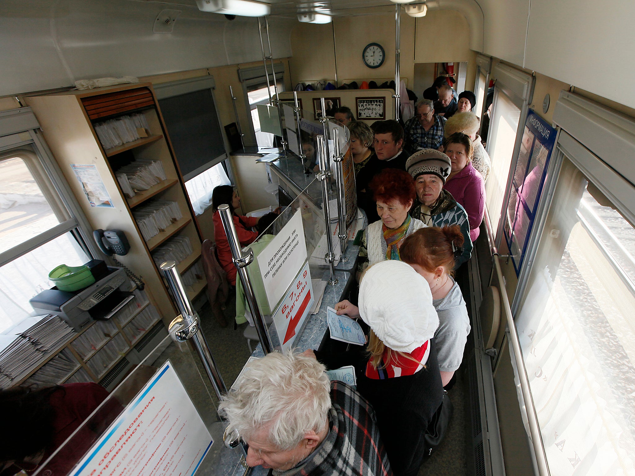 Patients stand in the registry line aboard the Doctor Voino-Yasenecky Saint Luka train, which serves as a free consultative and diagnostic medical centre