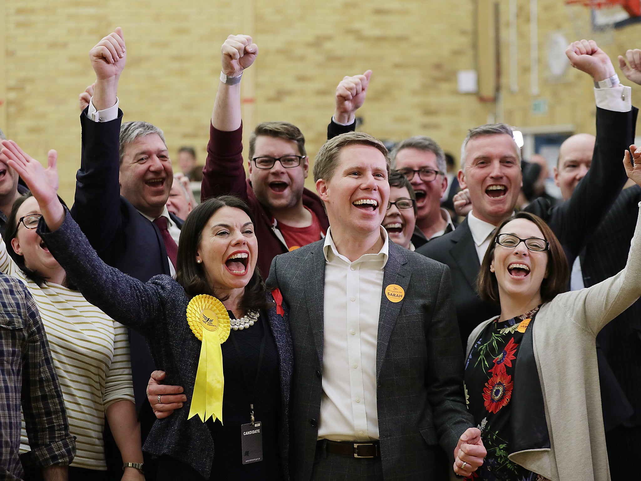 Liberal Democrat candidate Sarah Olney with her husband Ben and party supporters celebrate after winning the Richmond Park by-election