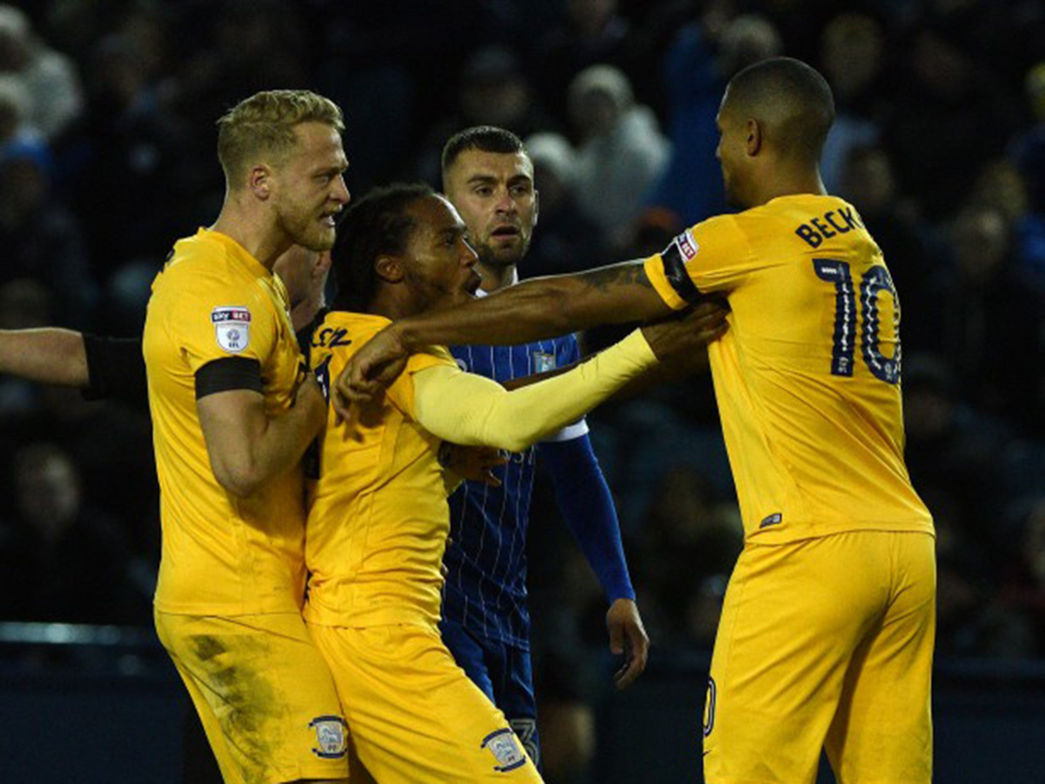 Beckford argues with his team mates after raising his hands to Doyle