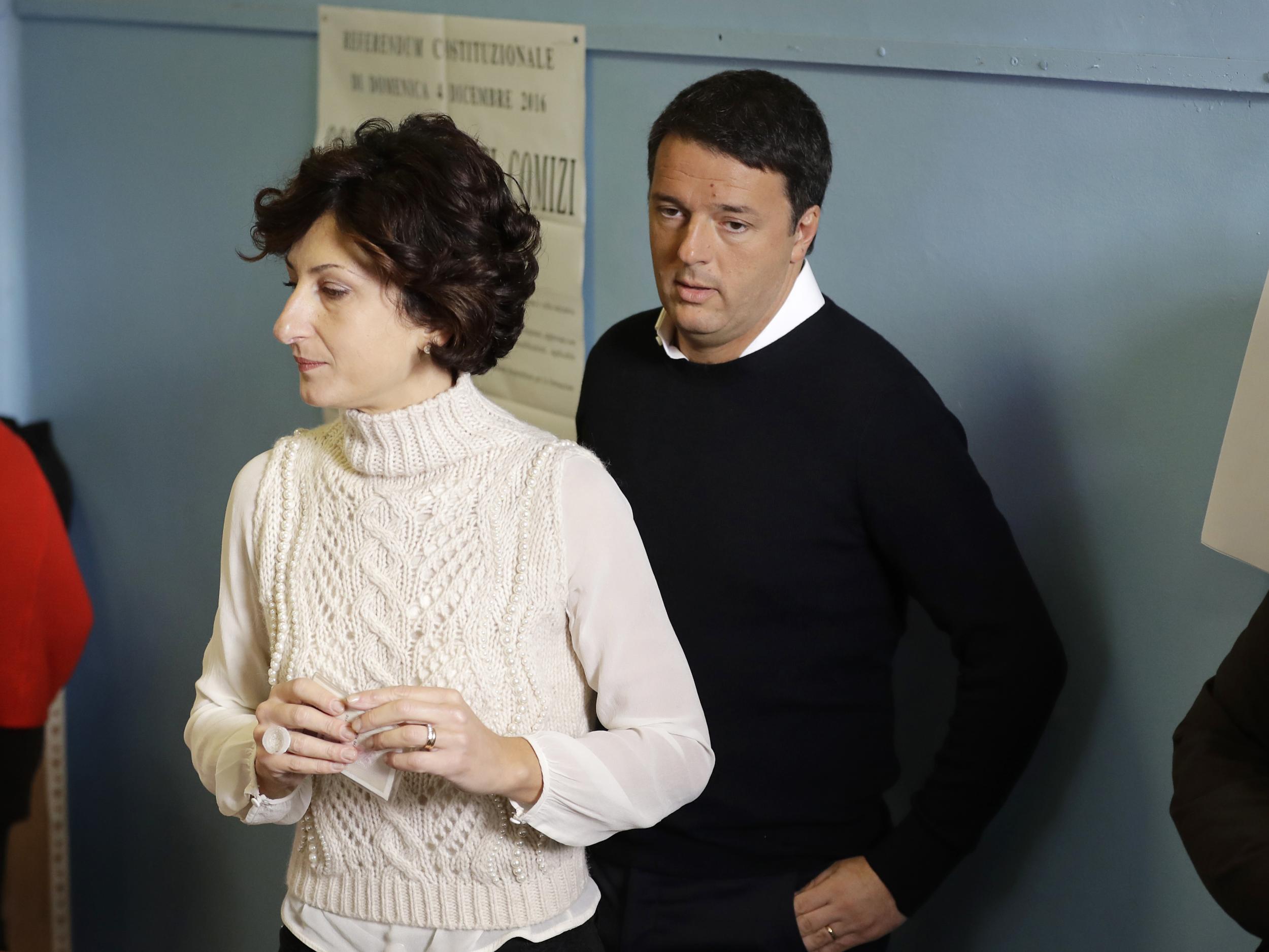 Italian Premier Matteo Renzi and his wife Agnese arrive at a polling station in Pontassieve