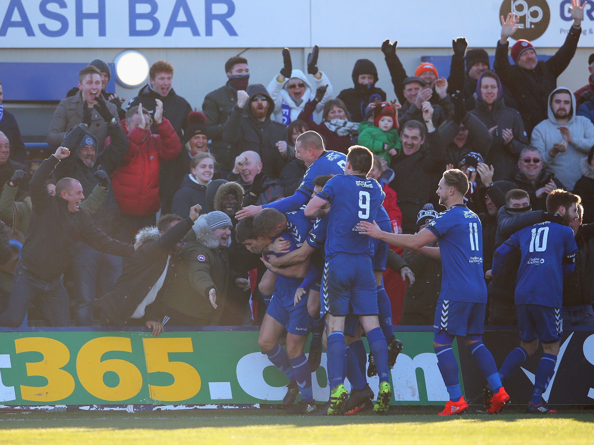 Adam Morgan and his team-mates celebrate with the home fans after scoring his third