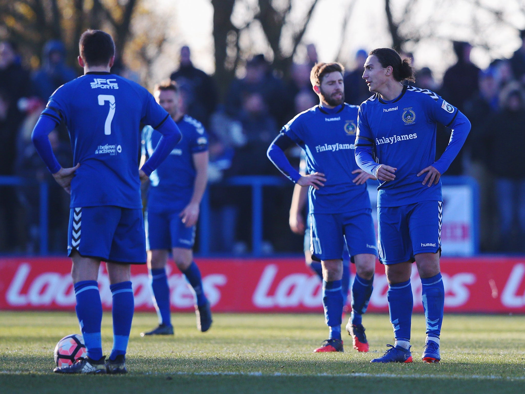 Curzon Ashton players look dejected following the final whistle