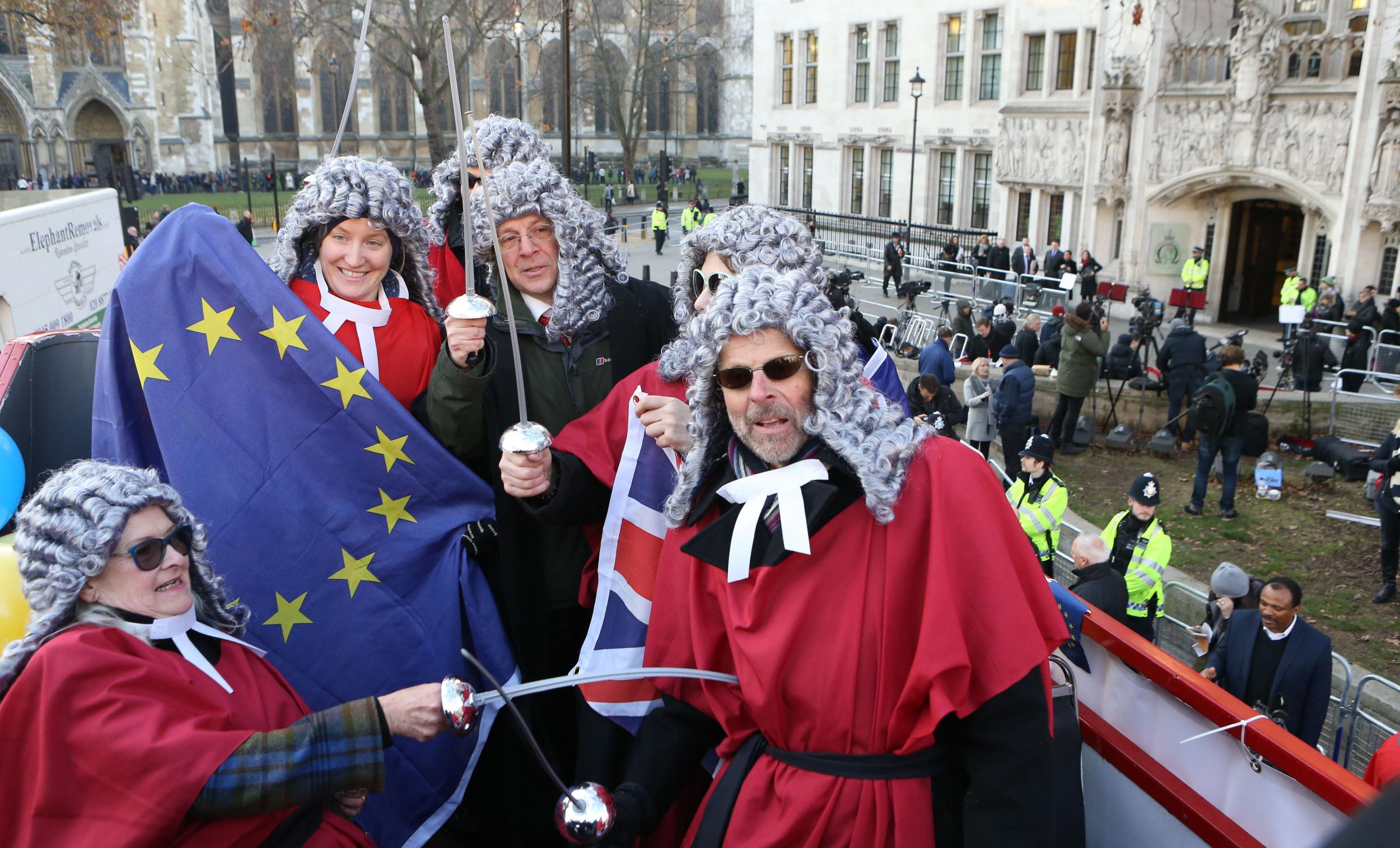 Brexit supporters dressed a judges on anti-EU bus outside the Supreme Court