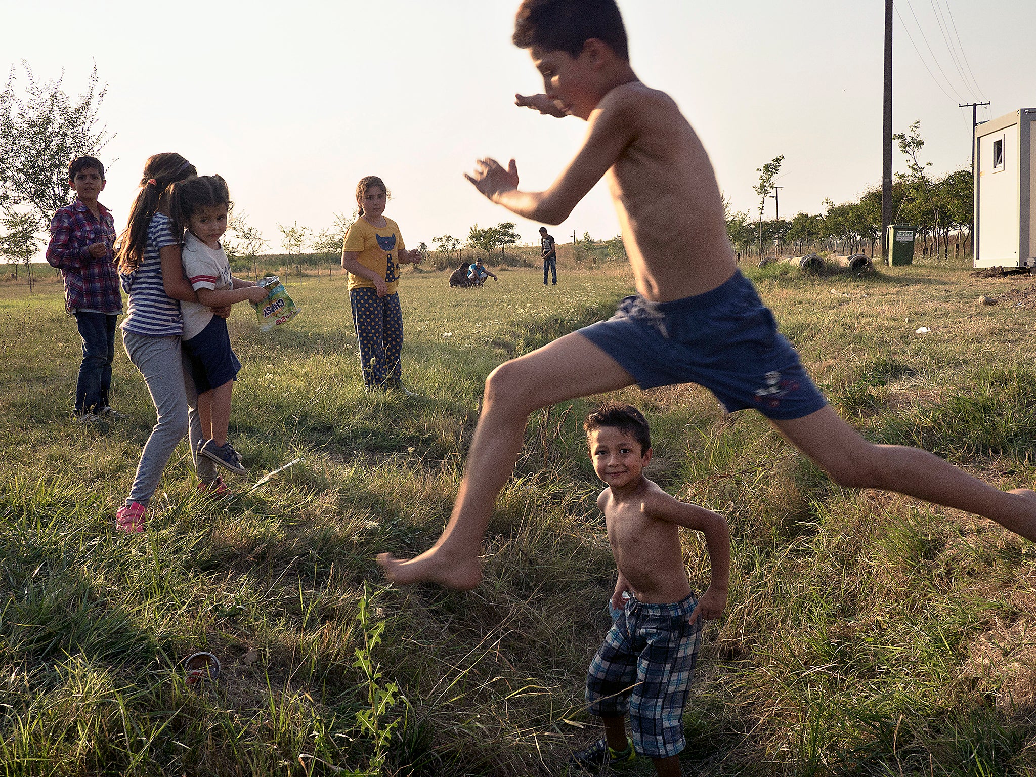 Life goes on for Syrian families, mostly from Aleppo, who have been placed in a refugee camp in Vasariste near the Serbian- Hungarian border (Jerome Sessini/Magnum)